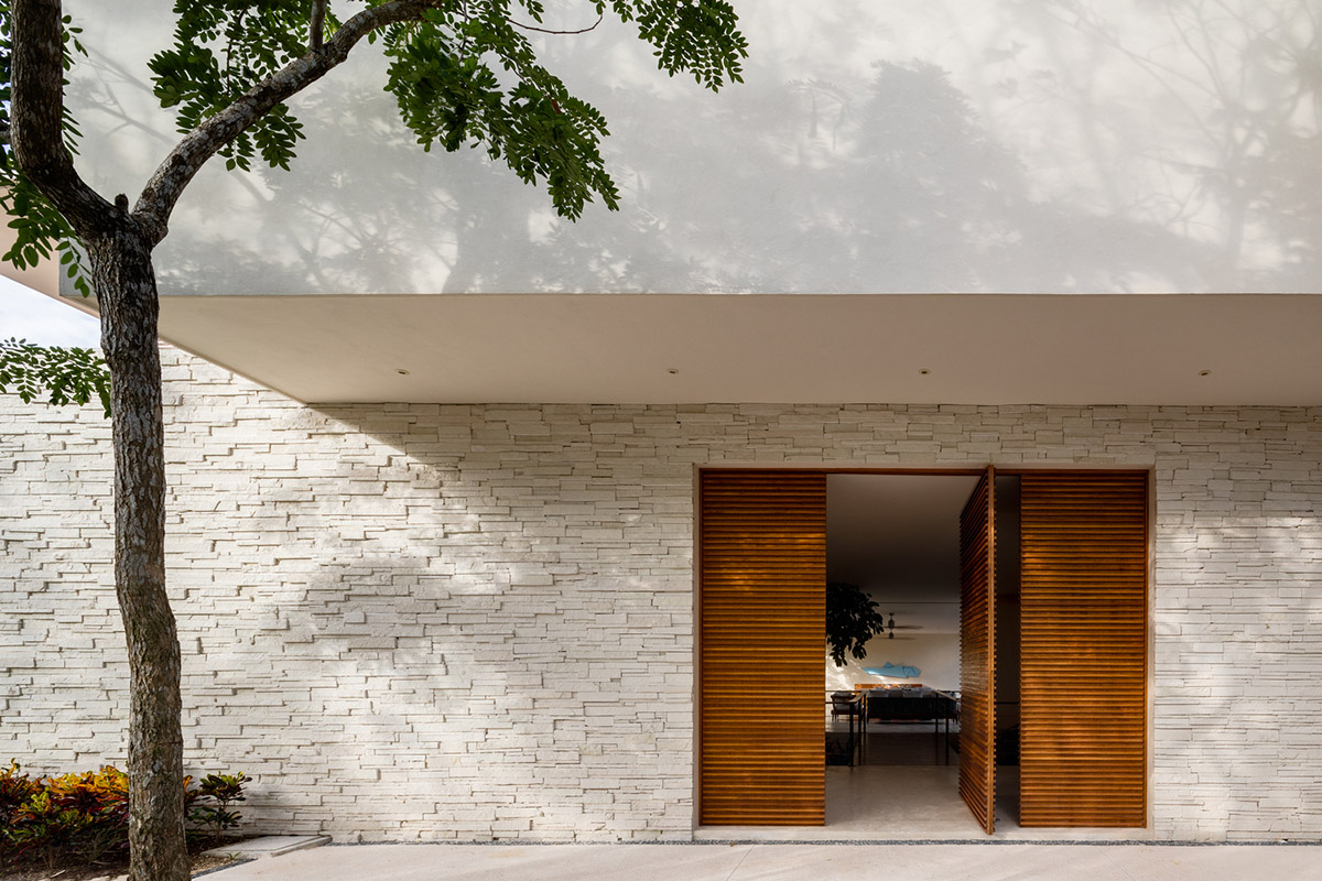 Sordo Madaleno Arquitectos' L-shaped residence disappears in a lush vegetation of Mexican island