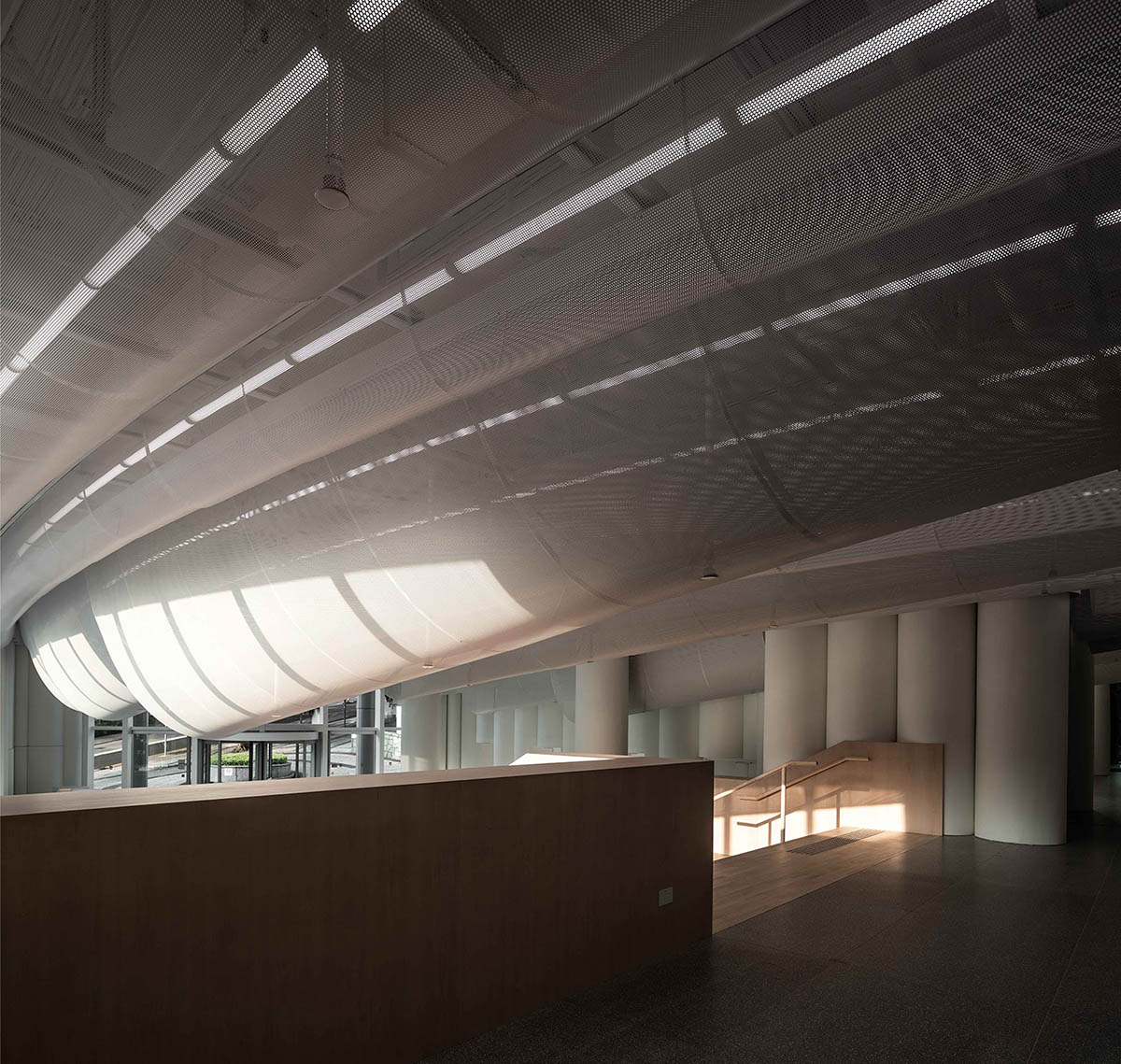 Atelier Nuno Architects suspends tubular aluminum panels from the ceiling of a lobby in Hong Kong