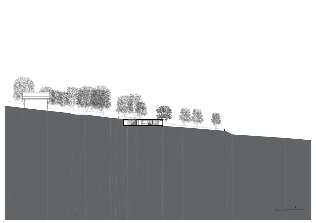 Studio Okami Architects built brick private villa embedded in the slope to offer infinite views