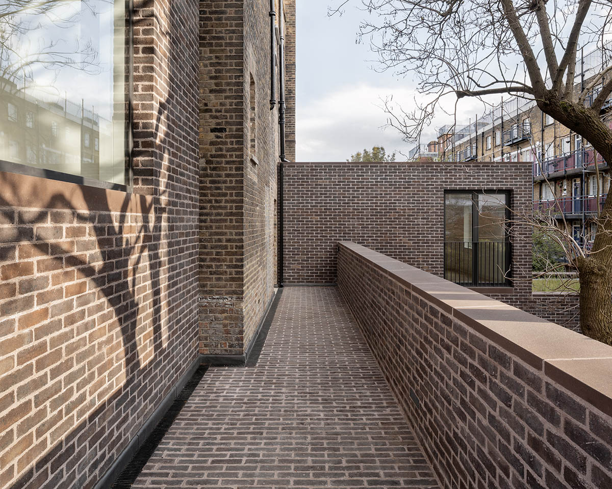 Erbar Mattes converts old pub into apartments in handmade grey-brown bricks in London 