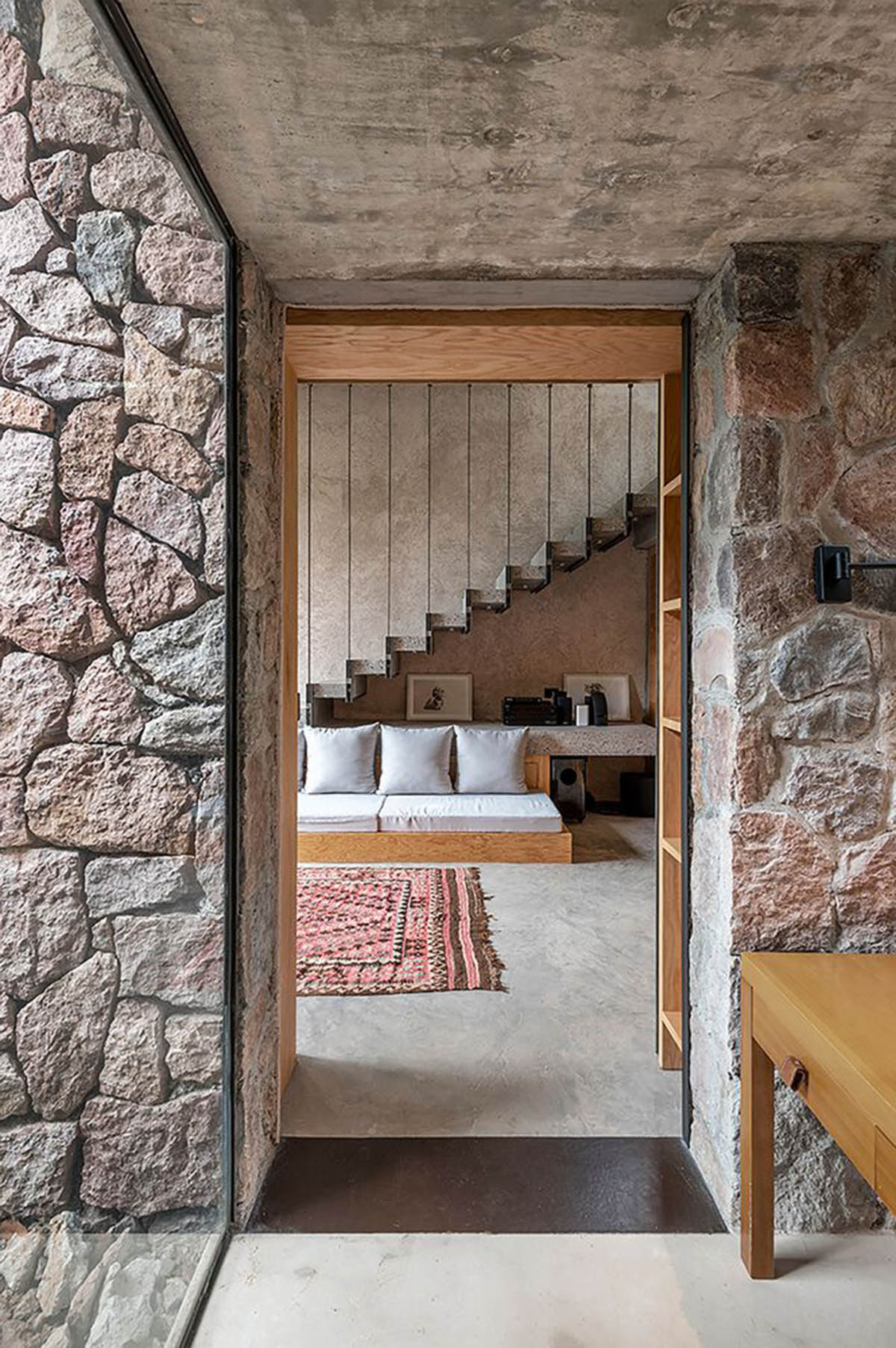 Luis Carbonell extends existing stone house with pastel-toned textured volume in a Mexican valley 