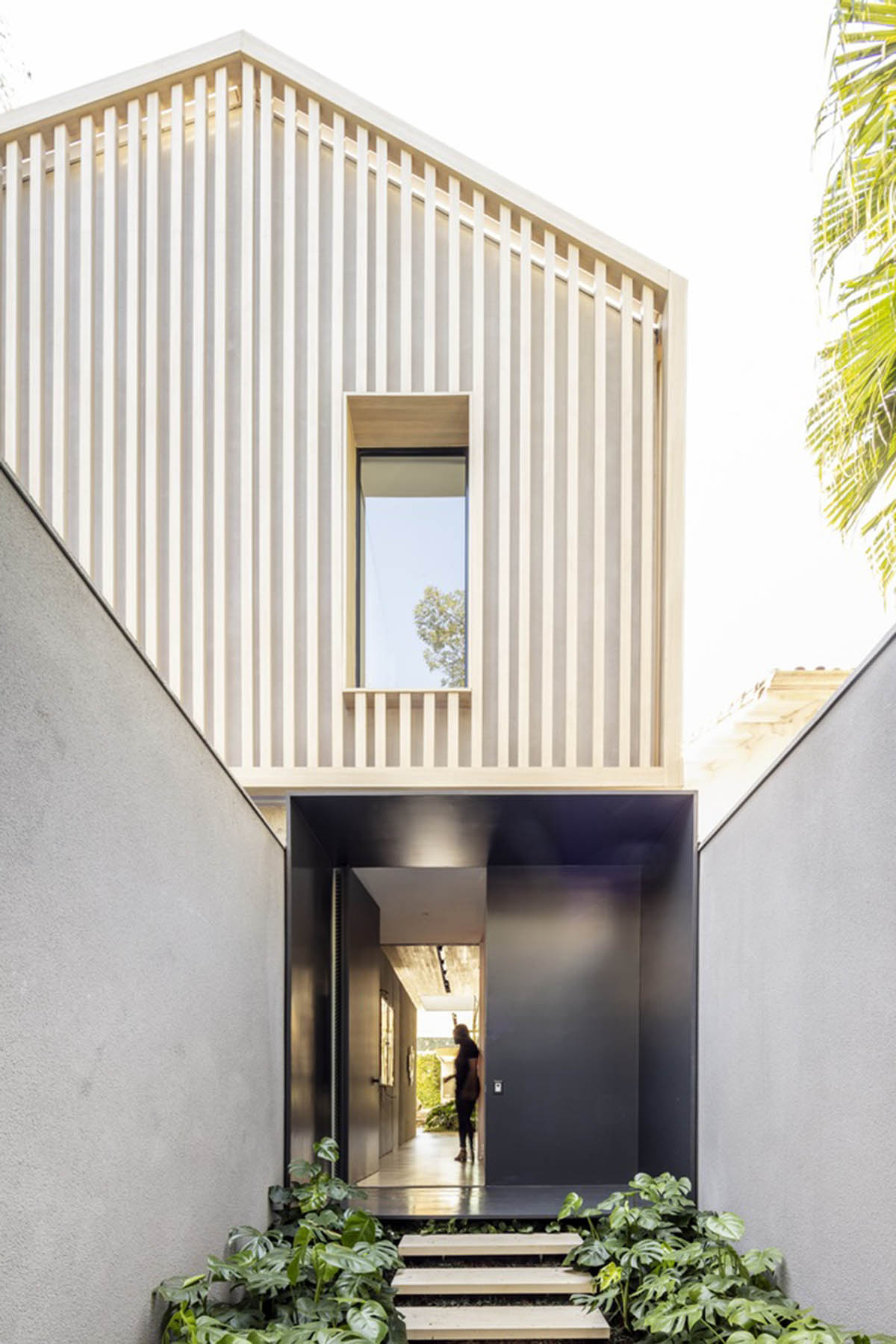Studio AG designed large wooden residence featuring punctured volumes with gabled roof in São Paulo