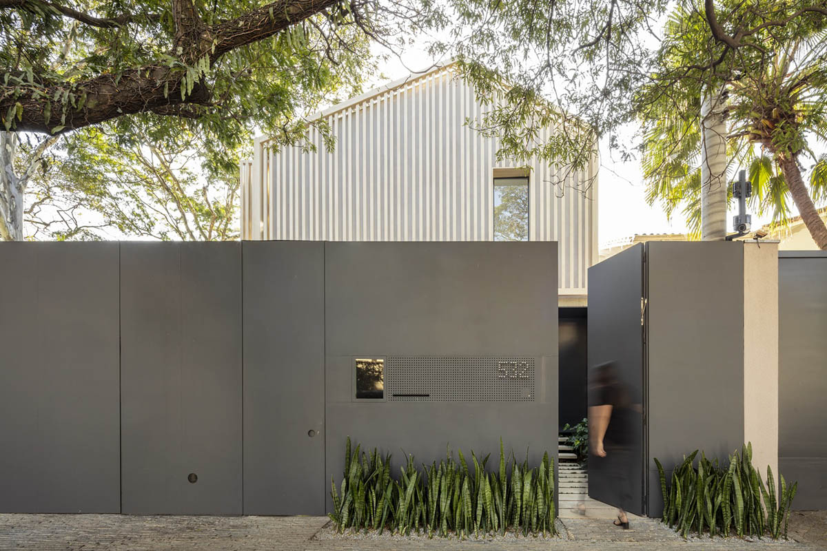 Studio AG designed large wooden residence featuring punctured volumes with gabled roof in São Paulo