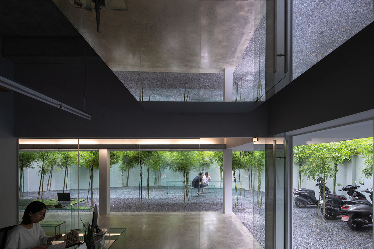 MIA Design Studio created vertical open library inside its office filled with greenery in Vietnam