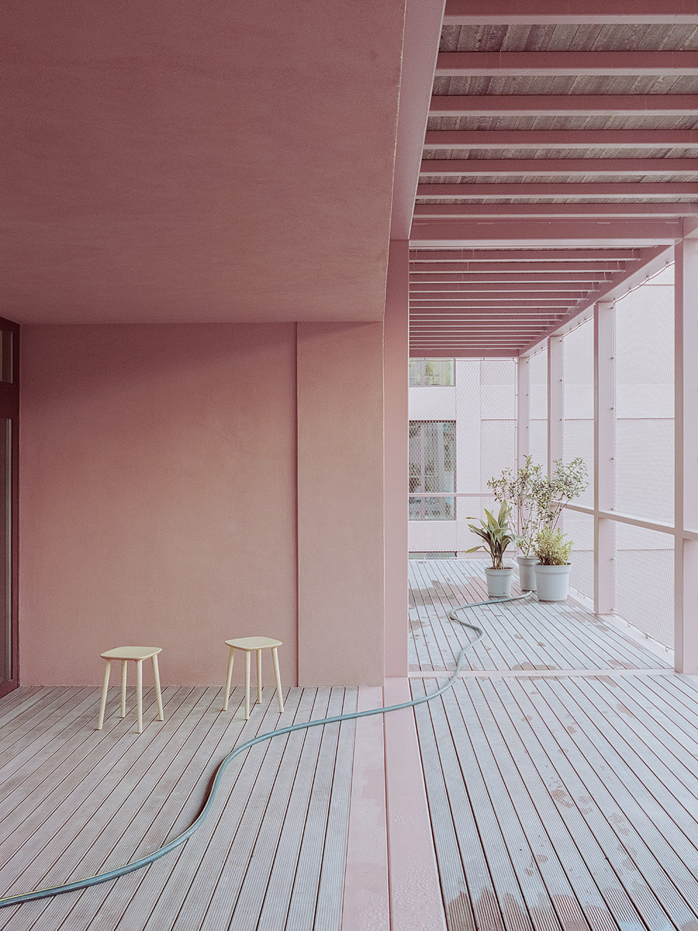 BDR bureau completes community school with pinkish steel framework in Turin