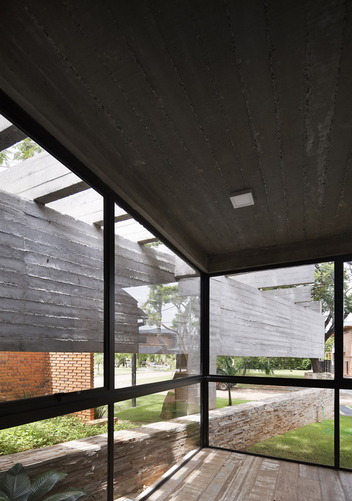 Concrete roof slabs and surfaces freely fly over this brick house in Paraguay by Culata Jovái Group