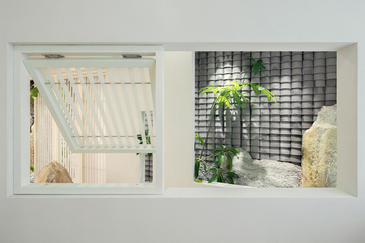 Jiejie studio wraps this tea room with a peach garden with rocky and forest landscape in Beijing