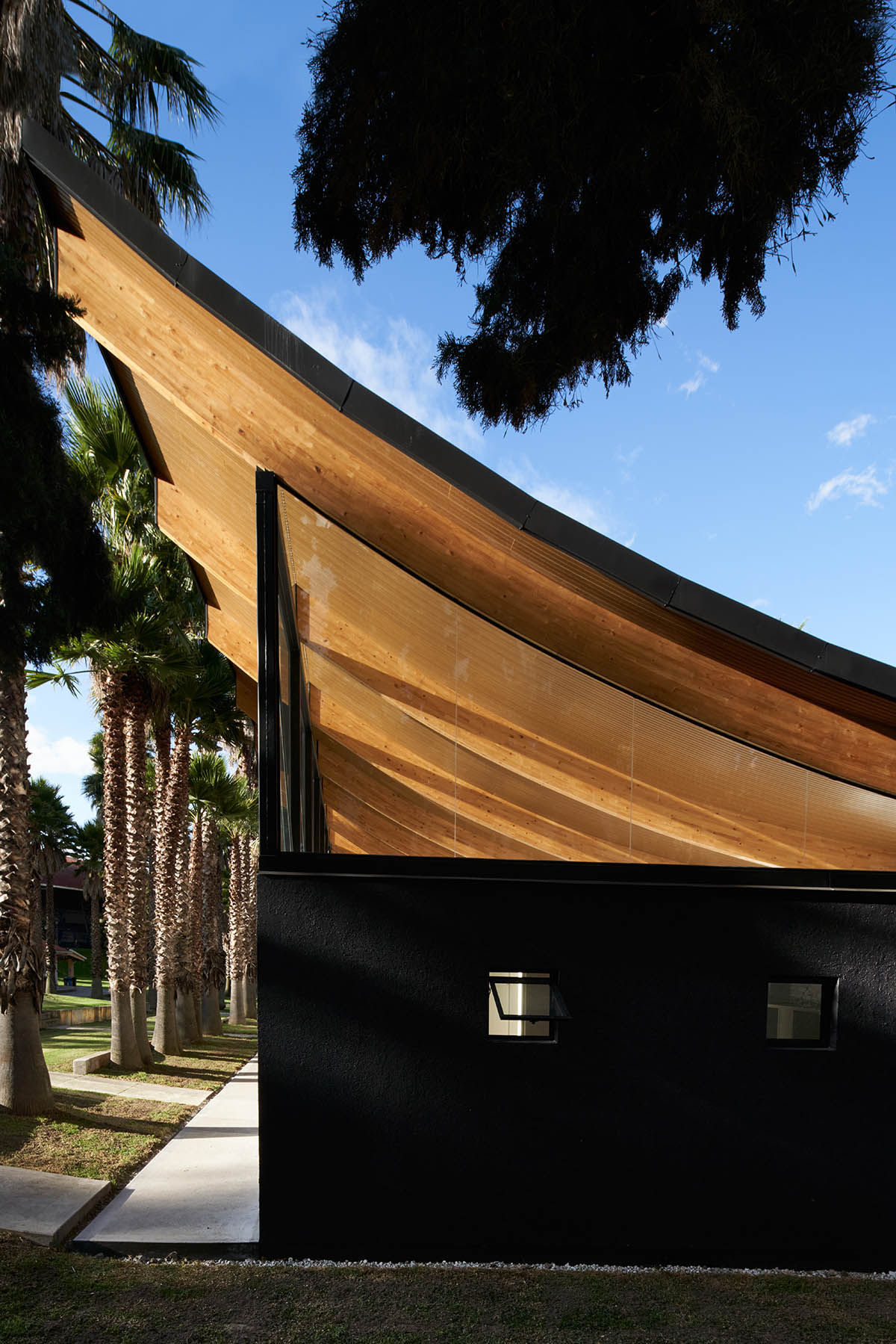 TEC Taller EC creates pavilion with concave wooden roof that becomes a façade in Ecuador