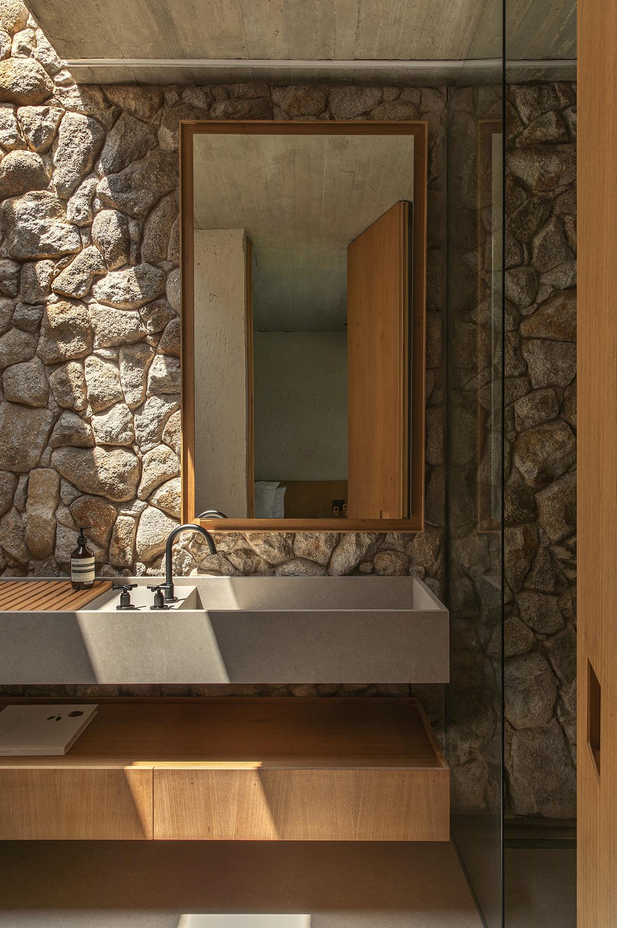 mf+arquitetos brings lightness to stone house with wooden louvres in Brazil 