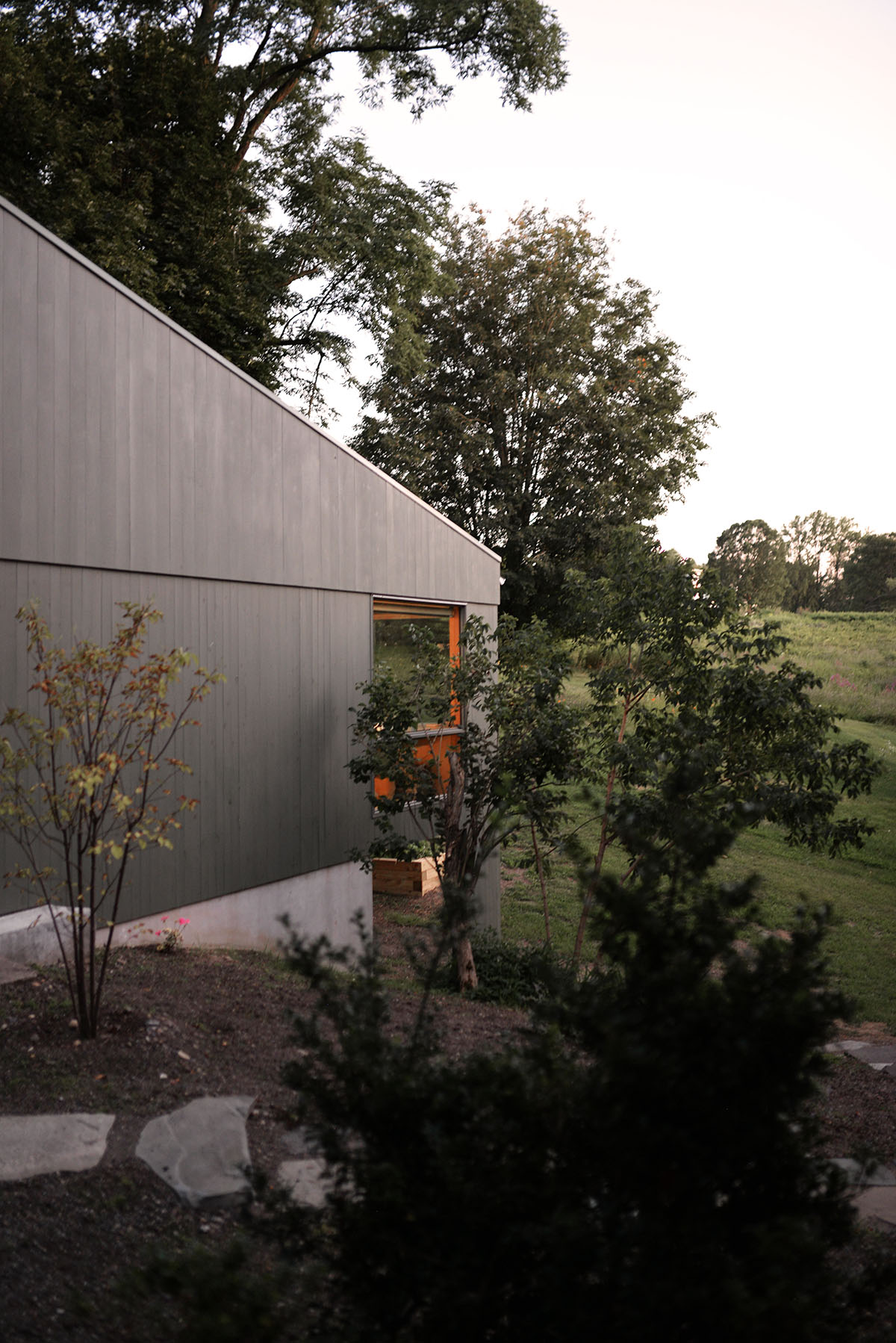 An artist's studio floats and illuminates in the landscape in Germantown