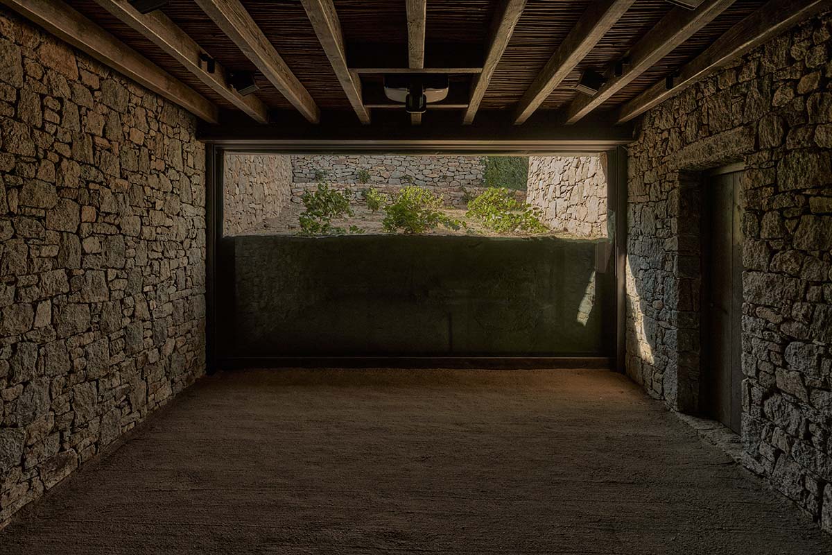 Terraced stonewalls sprawl down to offer an exploratory route in an old vineyard in Samos