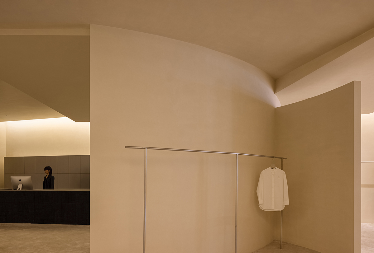 AD ARCHITECTURE designs store with light yellow curved walls that create comfort and softness 