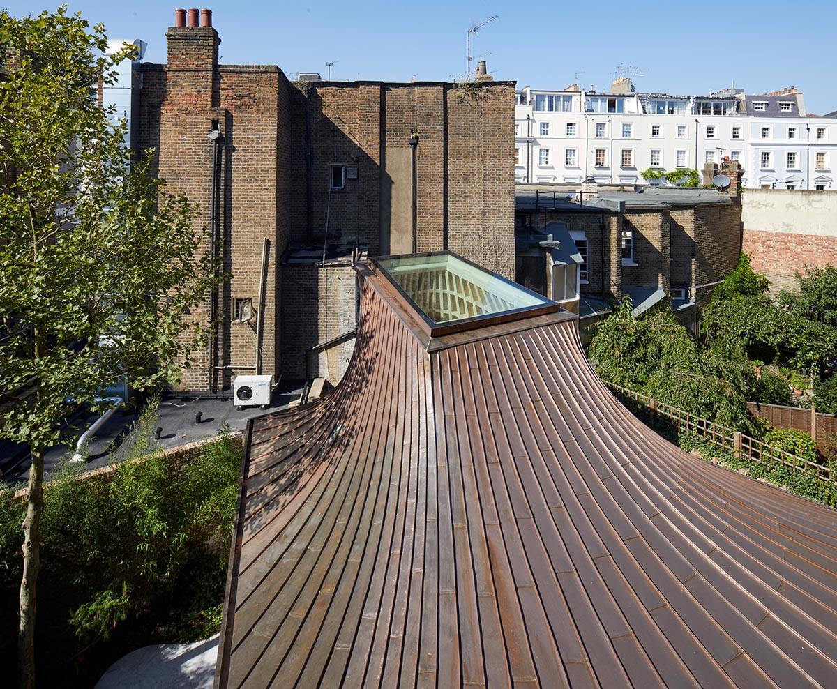 Gianni Botsford Architects transforms dilapidated bungalow with a giant copper clad roof in London