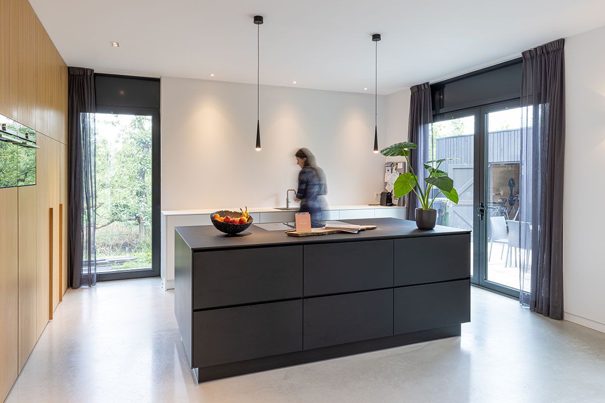 RoosRos Architecten completes black wooden-clad family house in an old ...