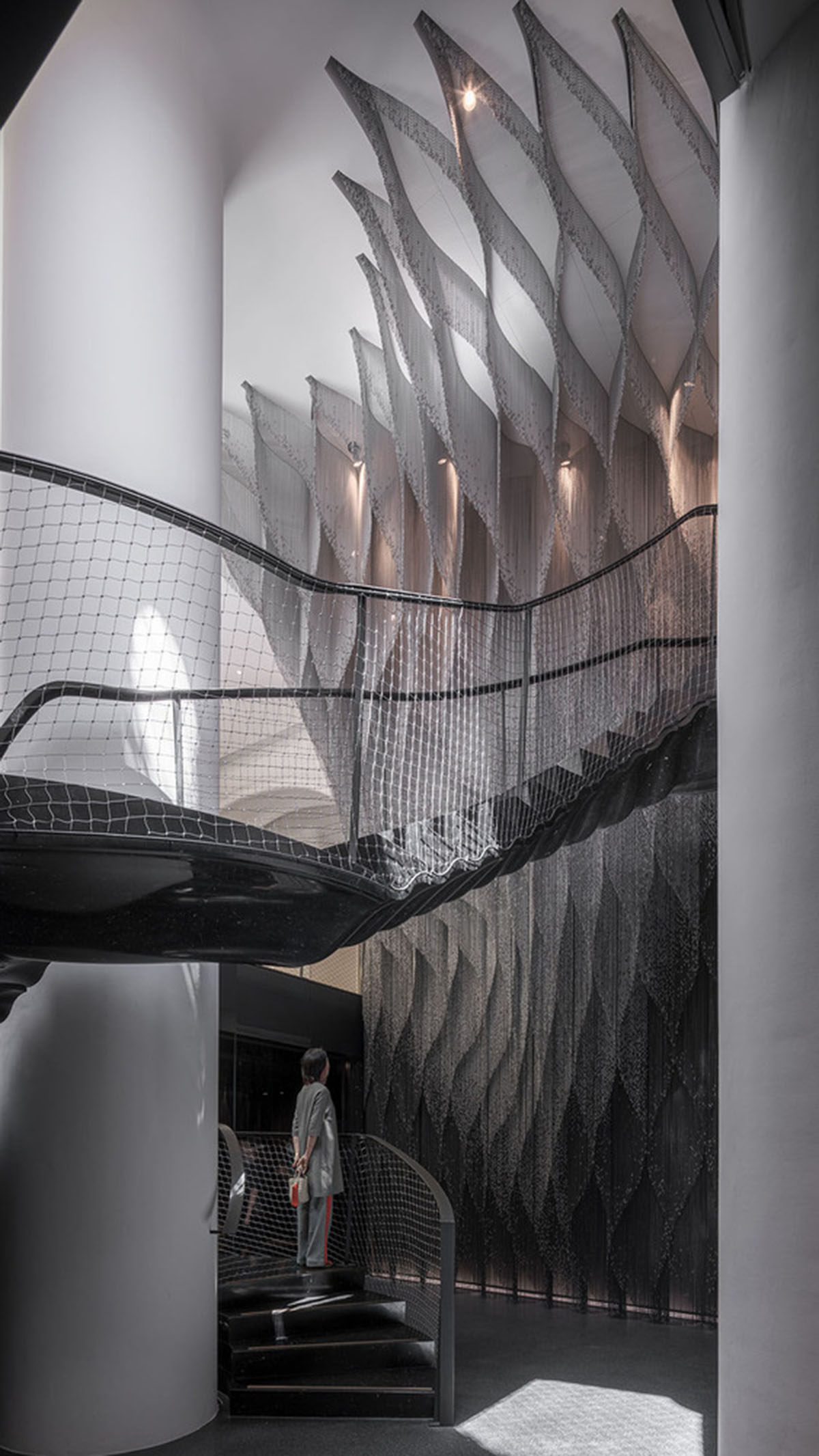 Kengo Kuma and Associates designs metal curtain with shades of grey at the atrium of Casa Batlló