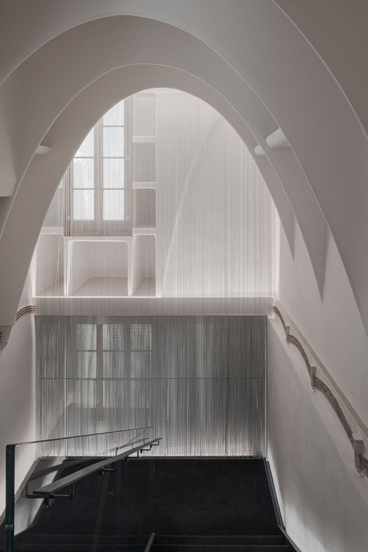 Kengo Kuma and Associates designs metal curtain with shades of grey at the atrium of Casa Batlló