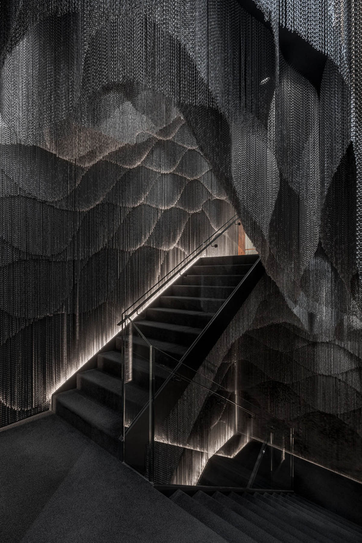 Kengo Kuma and Associates designs metal curtain with shades of grey at the atrium of Casa Batlló