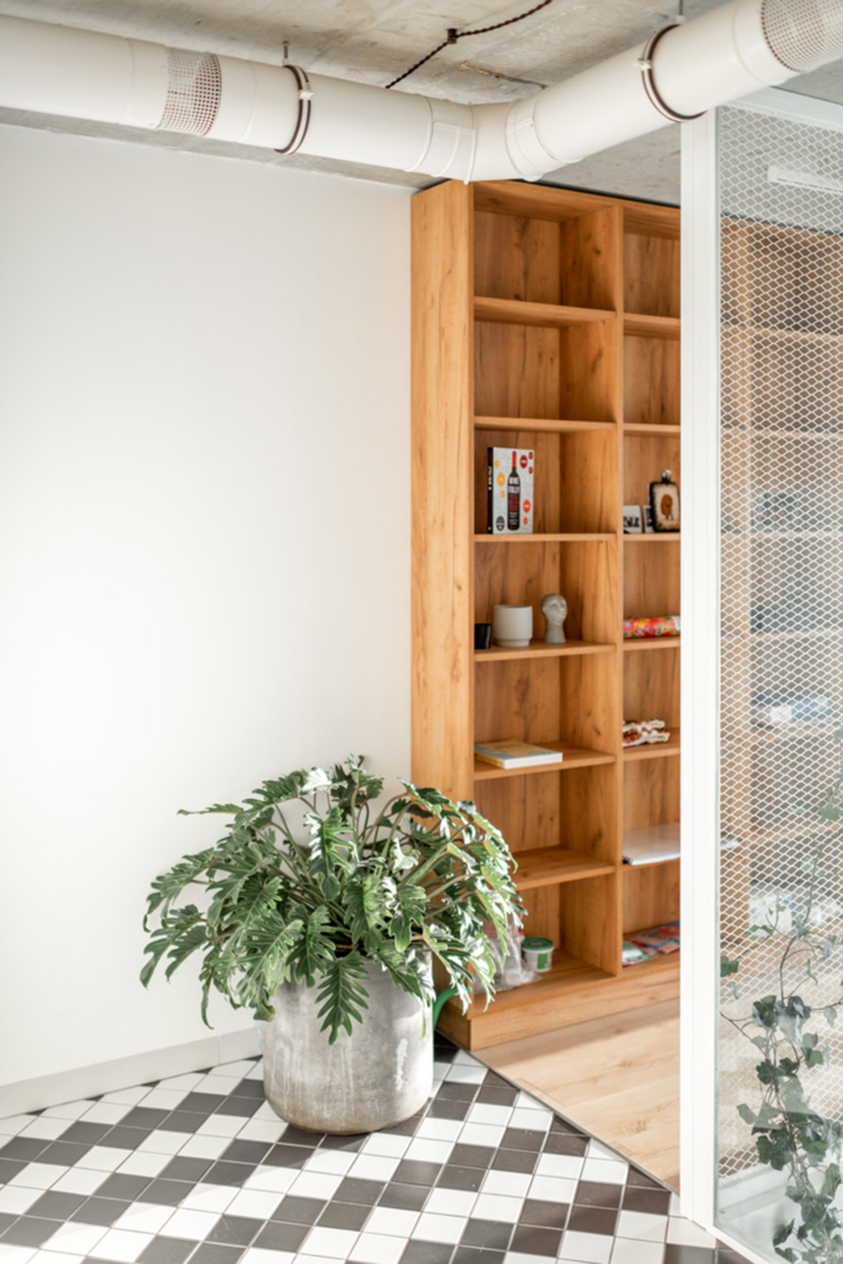 Metal framed-table, glass partitions, green infills make this interior space vivid and light in Lviv