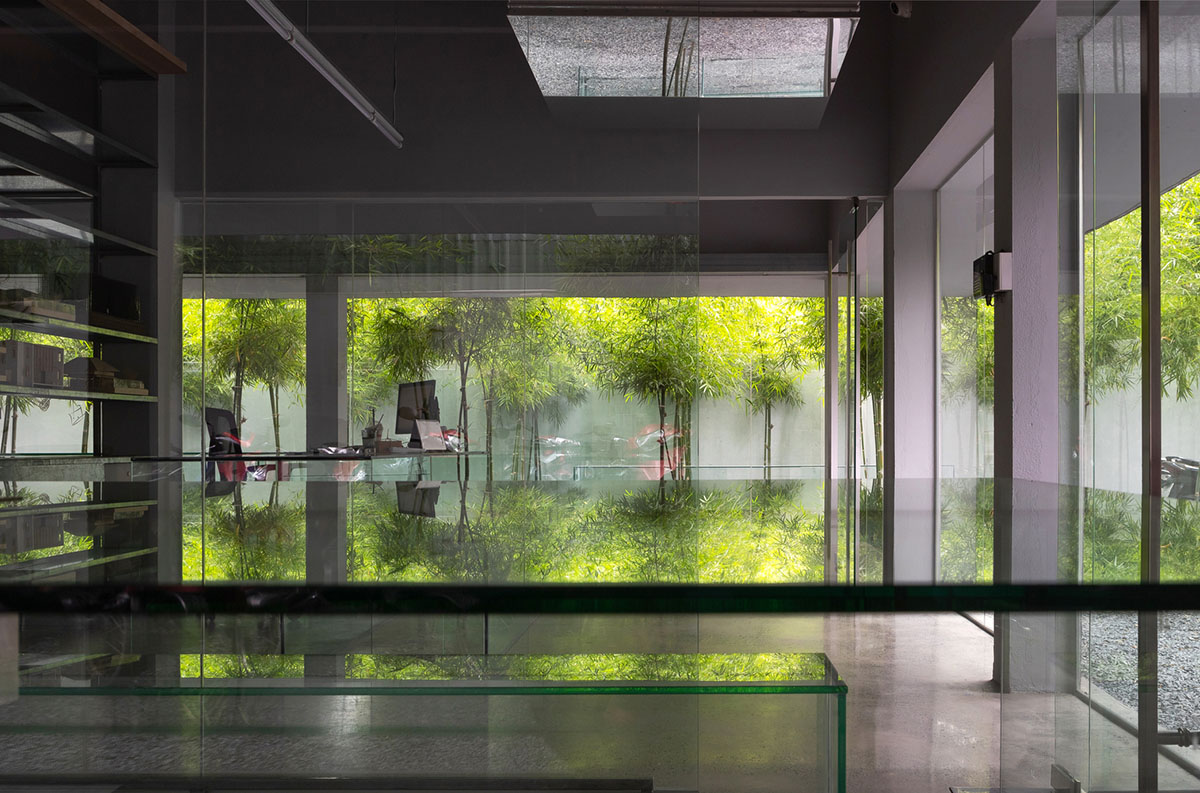 MIA Design Studio created vertical open library inside its office filled with greenery in Vietnam