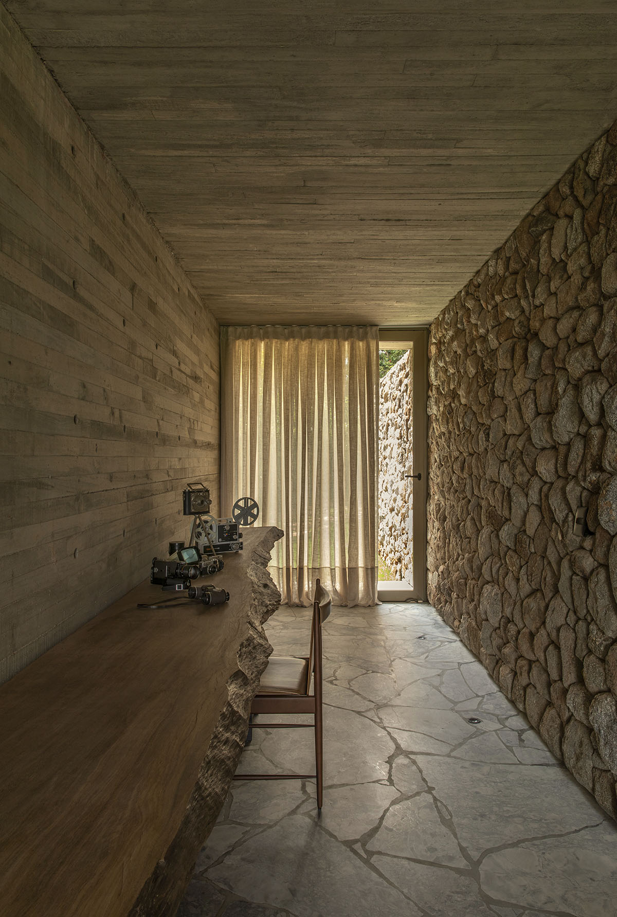 mf+arquitetos brings lightness to stone house with wooden louvres in Brazil 