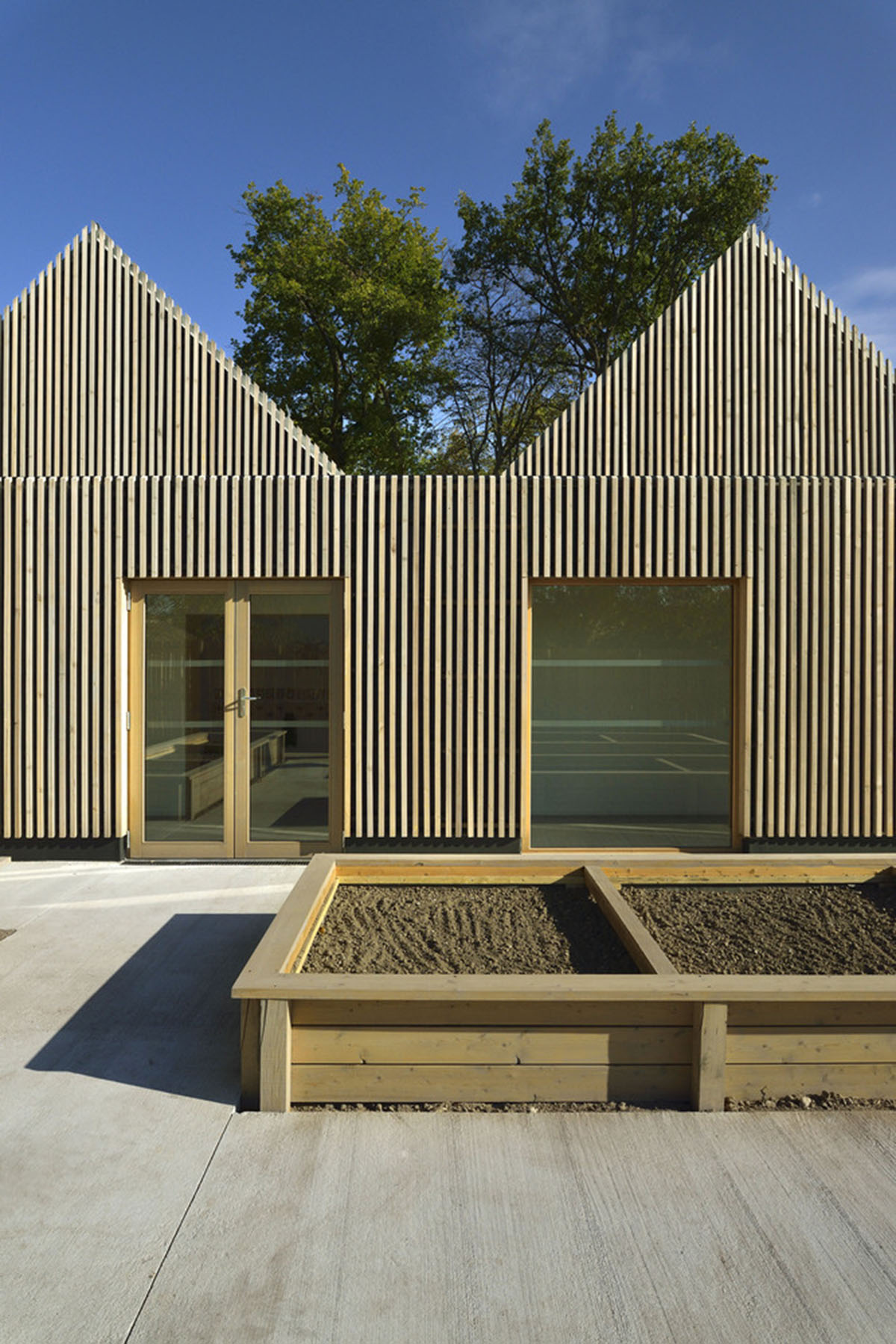 This human-scale school in French town wrapped by different geometry of wood claddings