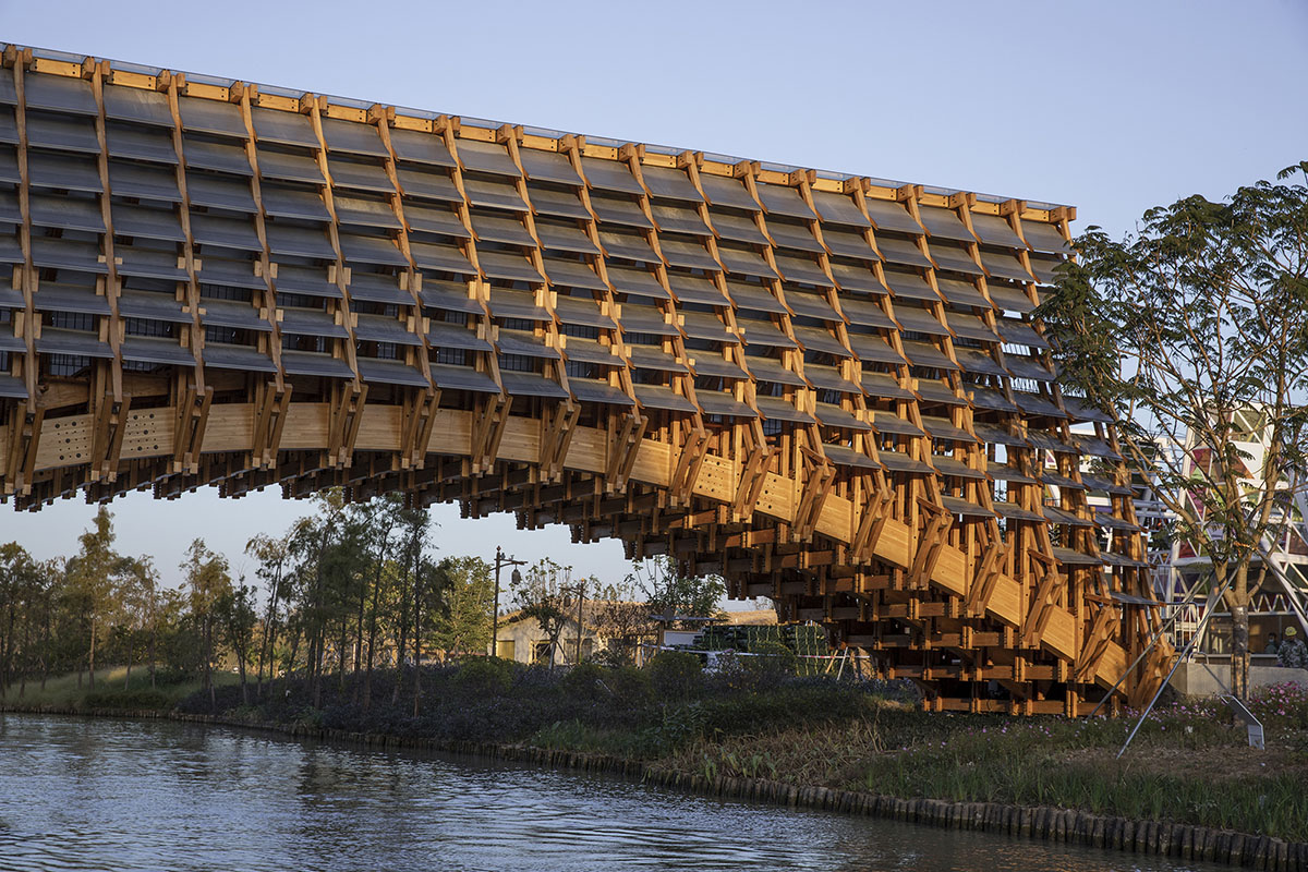 Arched timber bridge by LUO studio allows boats to pass under bridge smoothly in Gulou waterfront