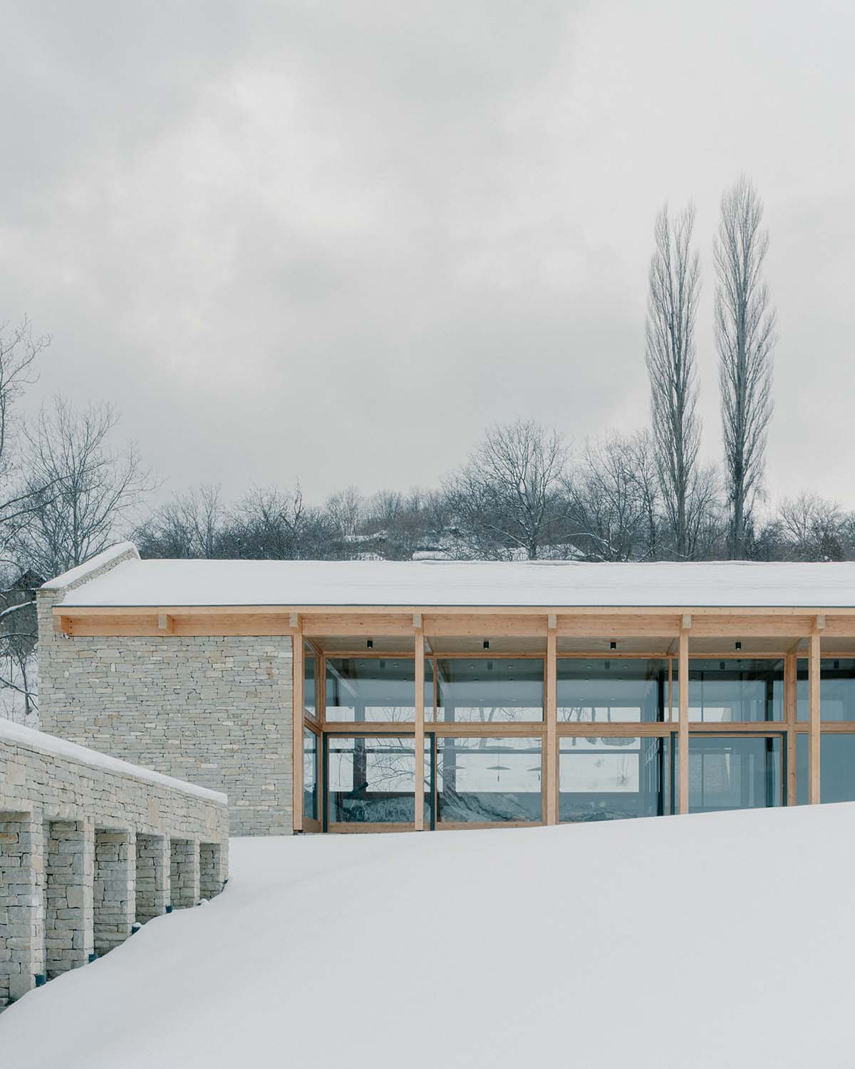 The stone and wood Tbilisi residence integrates architecture with the natural landscape