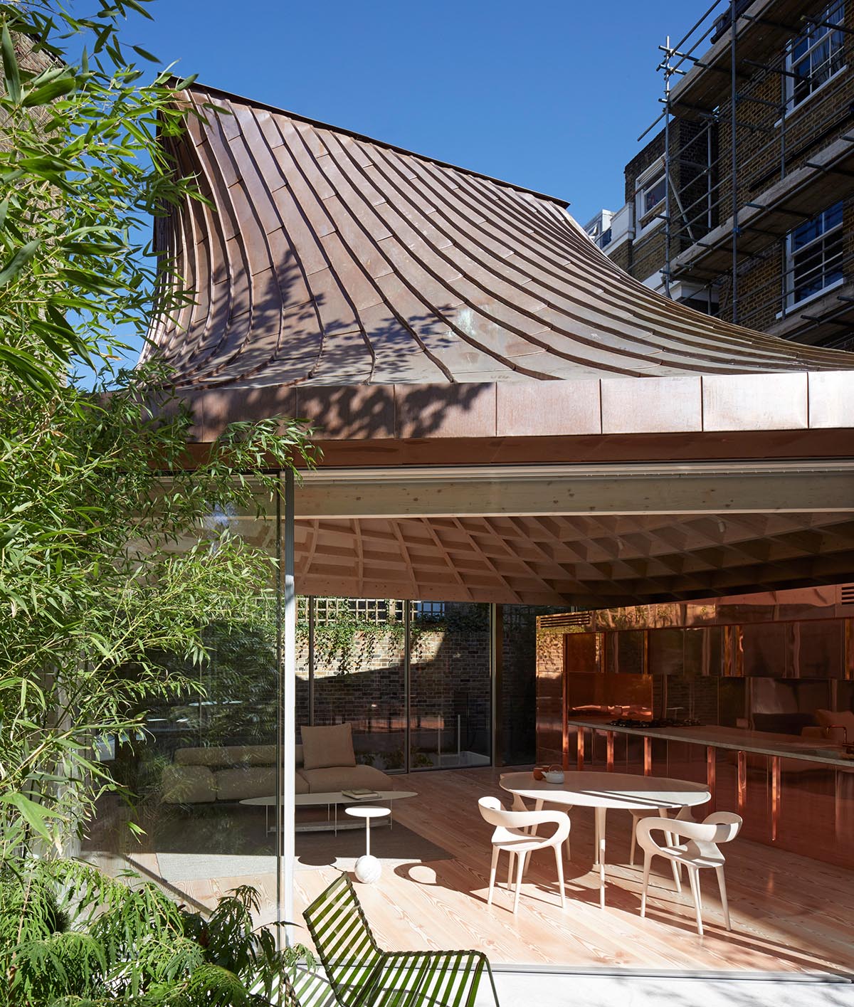 Gianni Botsford Architects transforms dilapidated bungalow with a giant copper clad roof in London