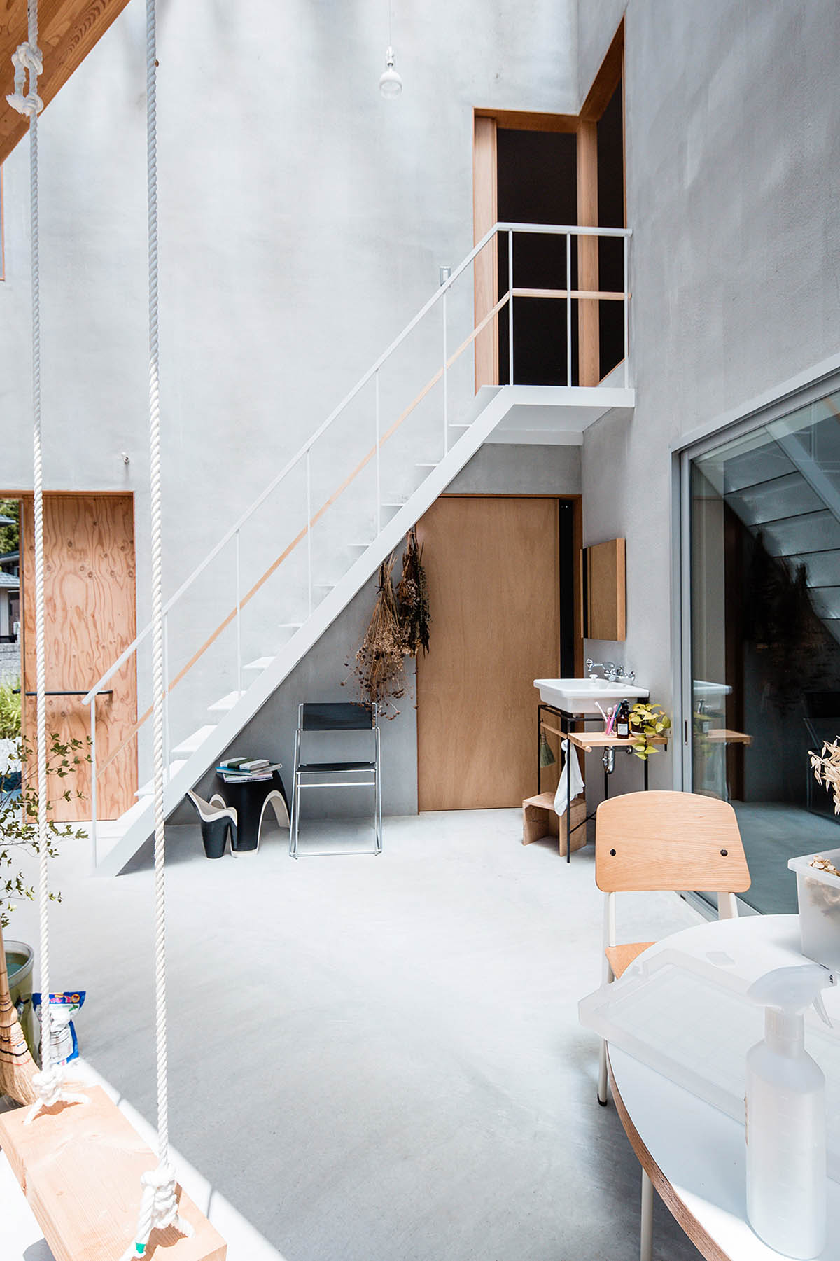 Huge corrugated polycarbonate wall lightens a cornered sunroom in house by Tato Architects