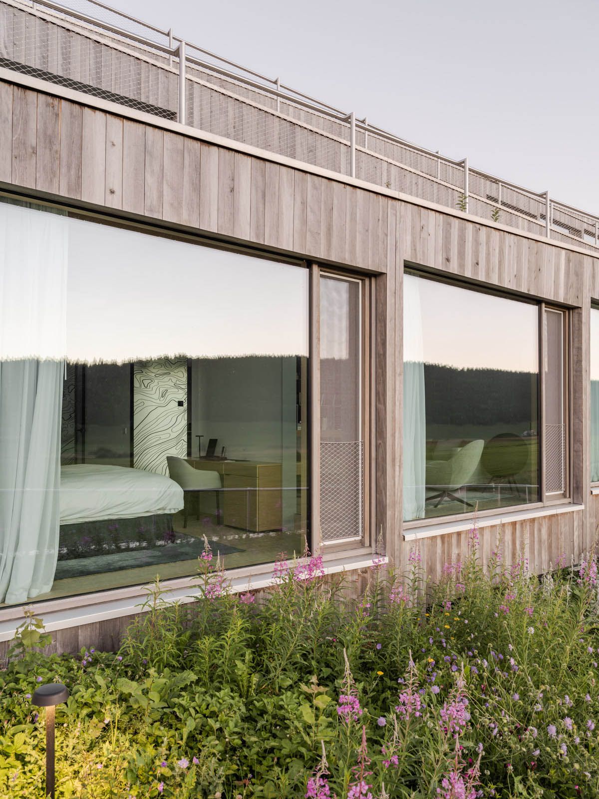 BIG reveals hotel with zigzagging slabs for watchmaker brand Audemars Piguet in Le Brassus