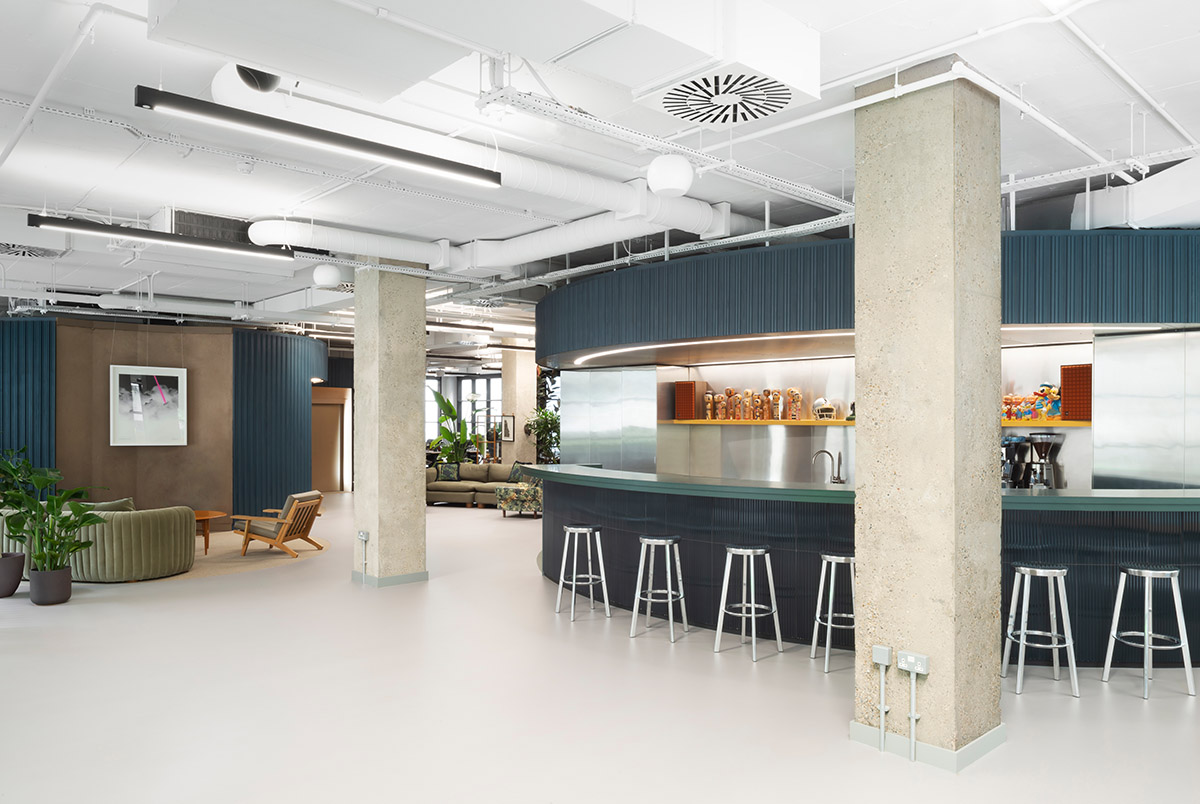 Office interiors by Bureau de Change Architects are shaped by colorful carved-out cylinders