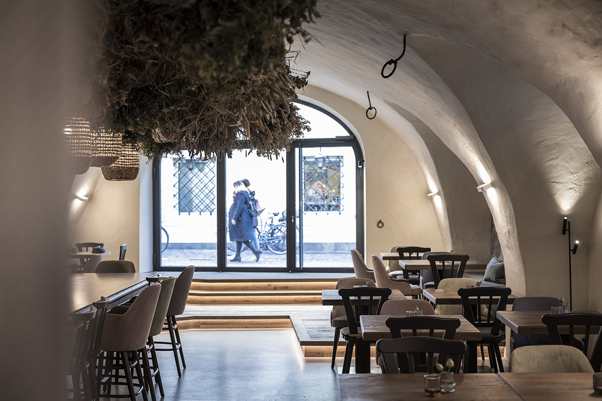 noa* transforms 19th-century workshop house into bohemian-style bistro with deep alcoves in Italy