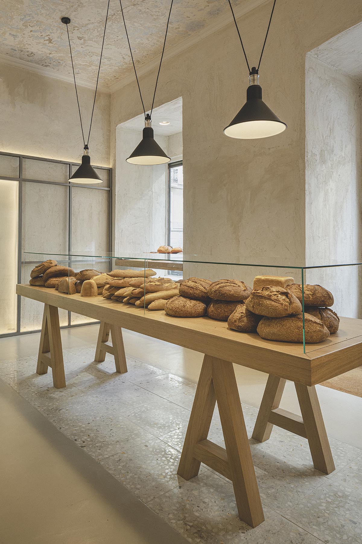 Bakery features central oak tables that revive the traditional dining room experience 
