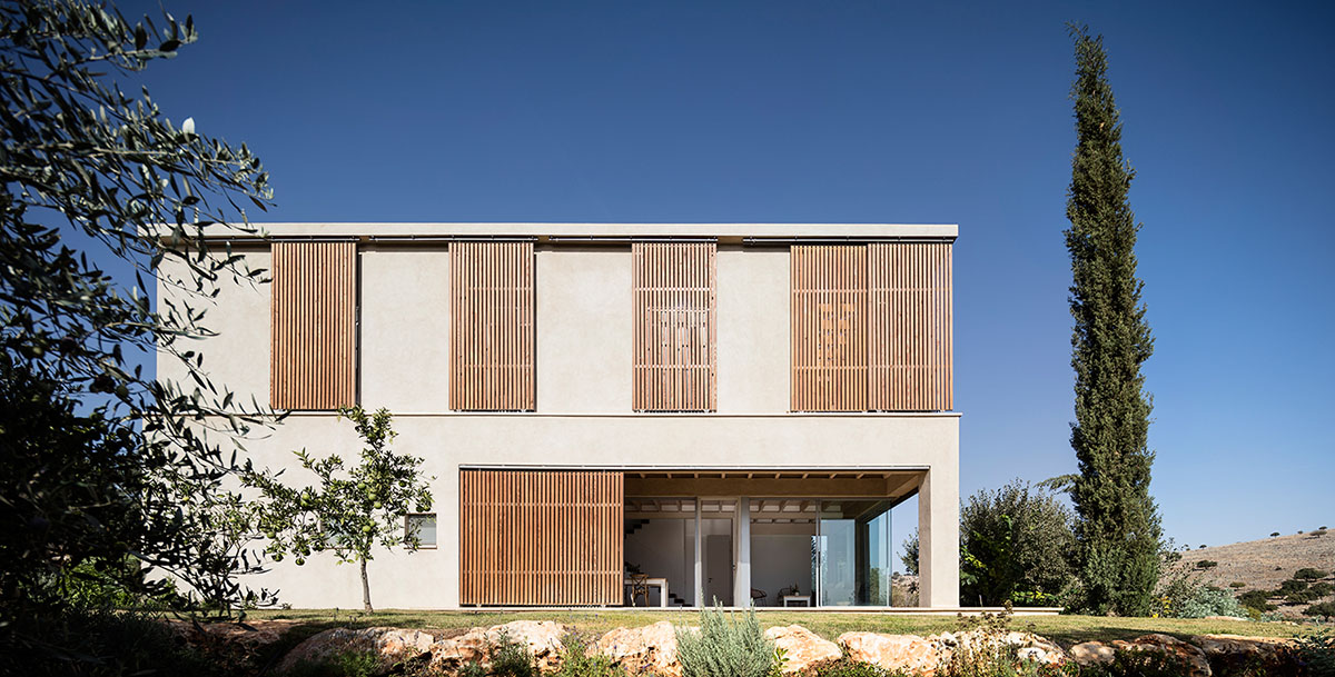 Golany Architects completes concrete private residence with wooden shutters in the Galilee