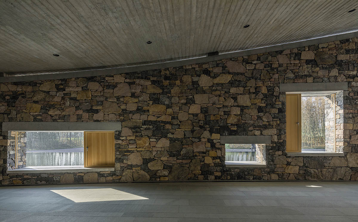 Concrete hyperboloid roofs cover masonry stone art center with a central courtyard in Shandong