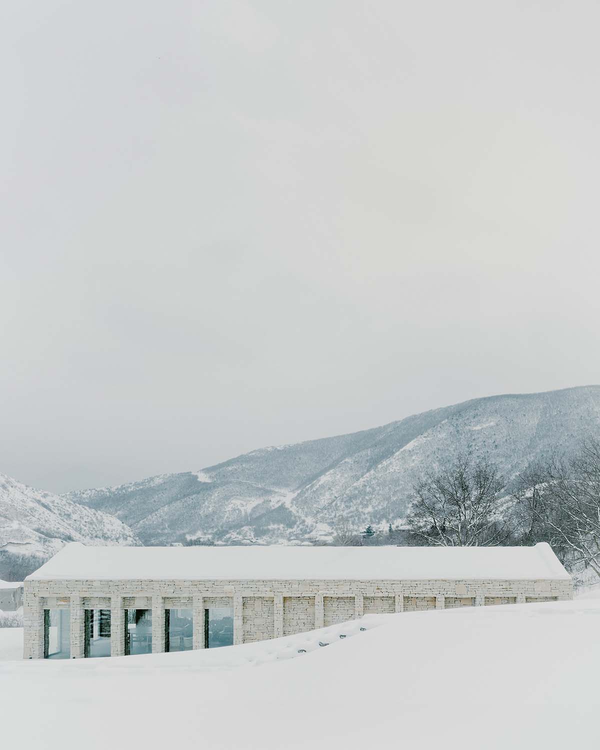 The stone and wood Tbilisi residence integrates architecture with the natural landscape