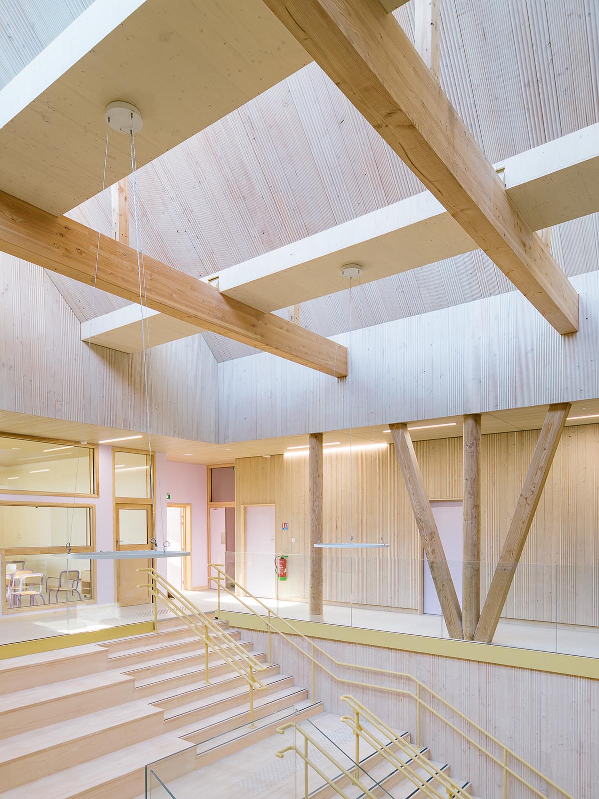 Wooden school by r2k architecte is inspired by Nordic architecture to be a positive energy building