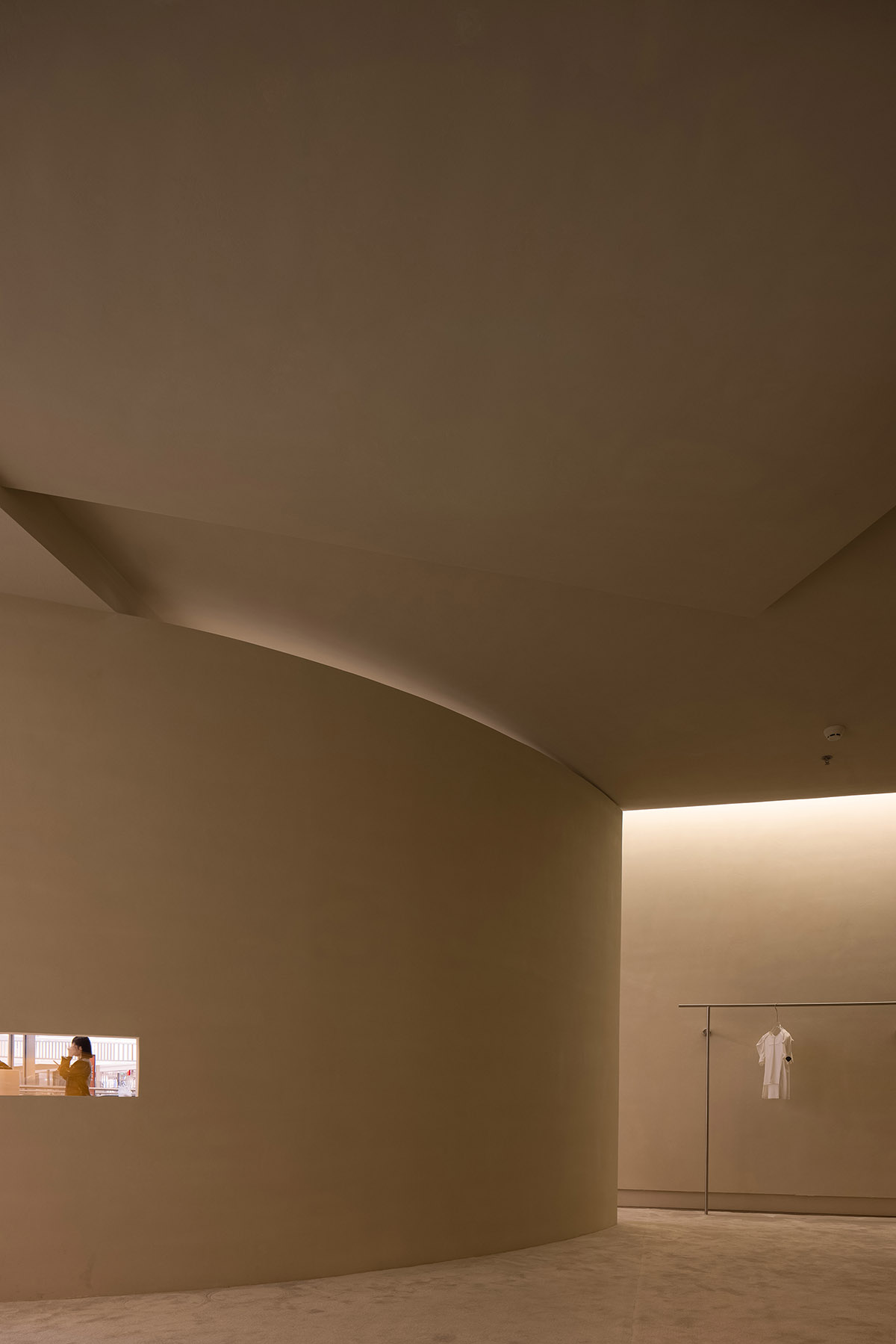 AD ARCHITECTURE designs store with light yellow curved walls that create comfort and softness 