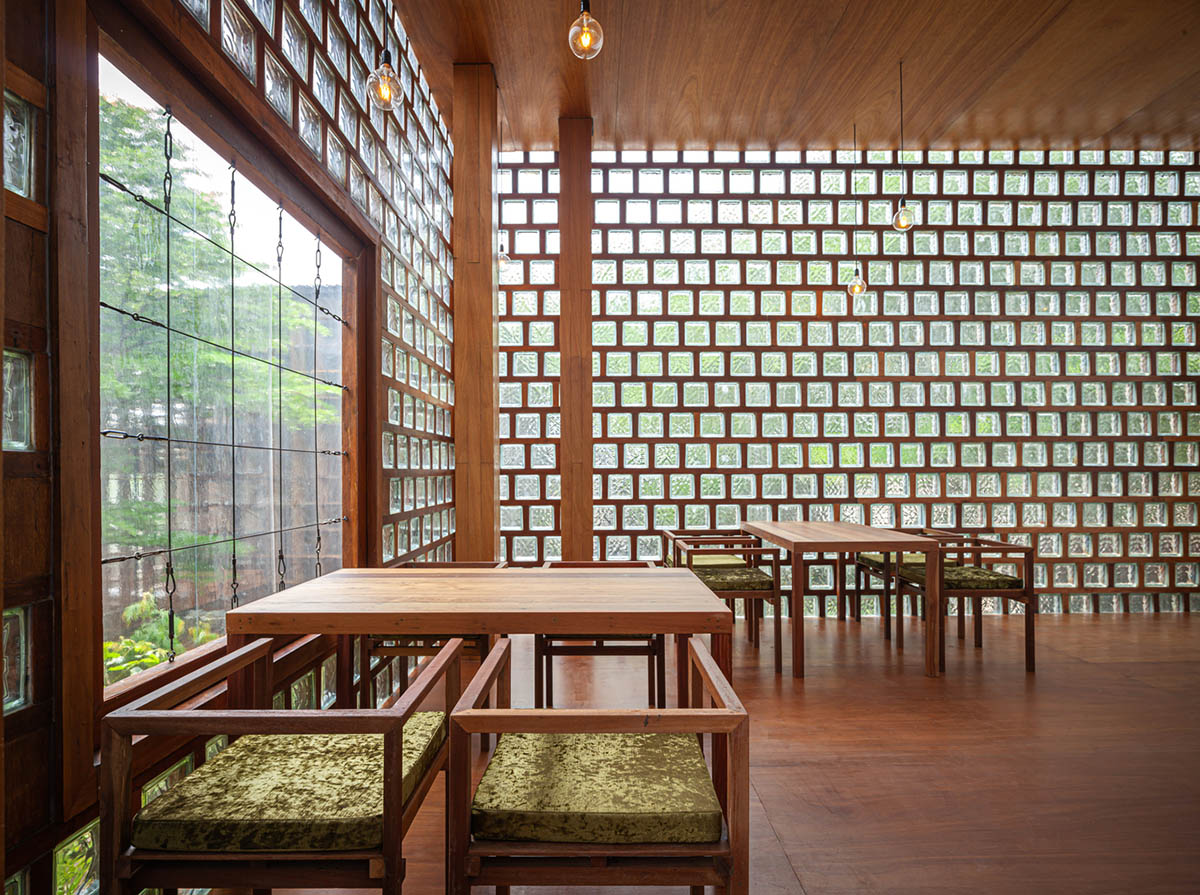 Five glass blocks with framed wood form this woman restaurant designed by Bangkok Project Studio