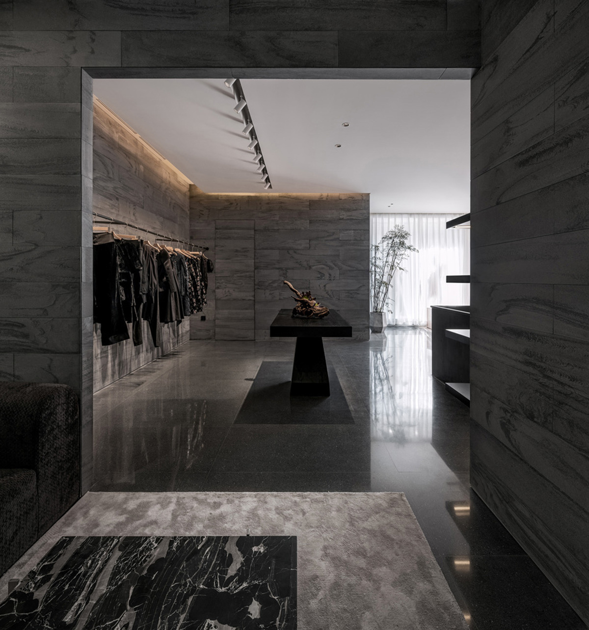 Pink elements and dark colors create sharp contrast in the interiors of restaurant and showroom