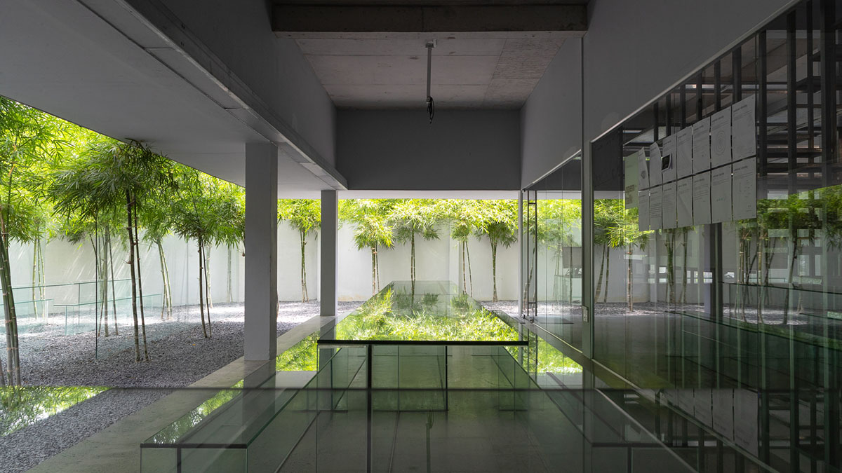 MIA Design Studio created vertical open library inside its office filled with greenery in Vietnam