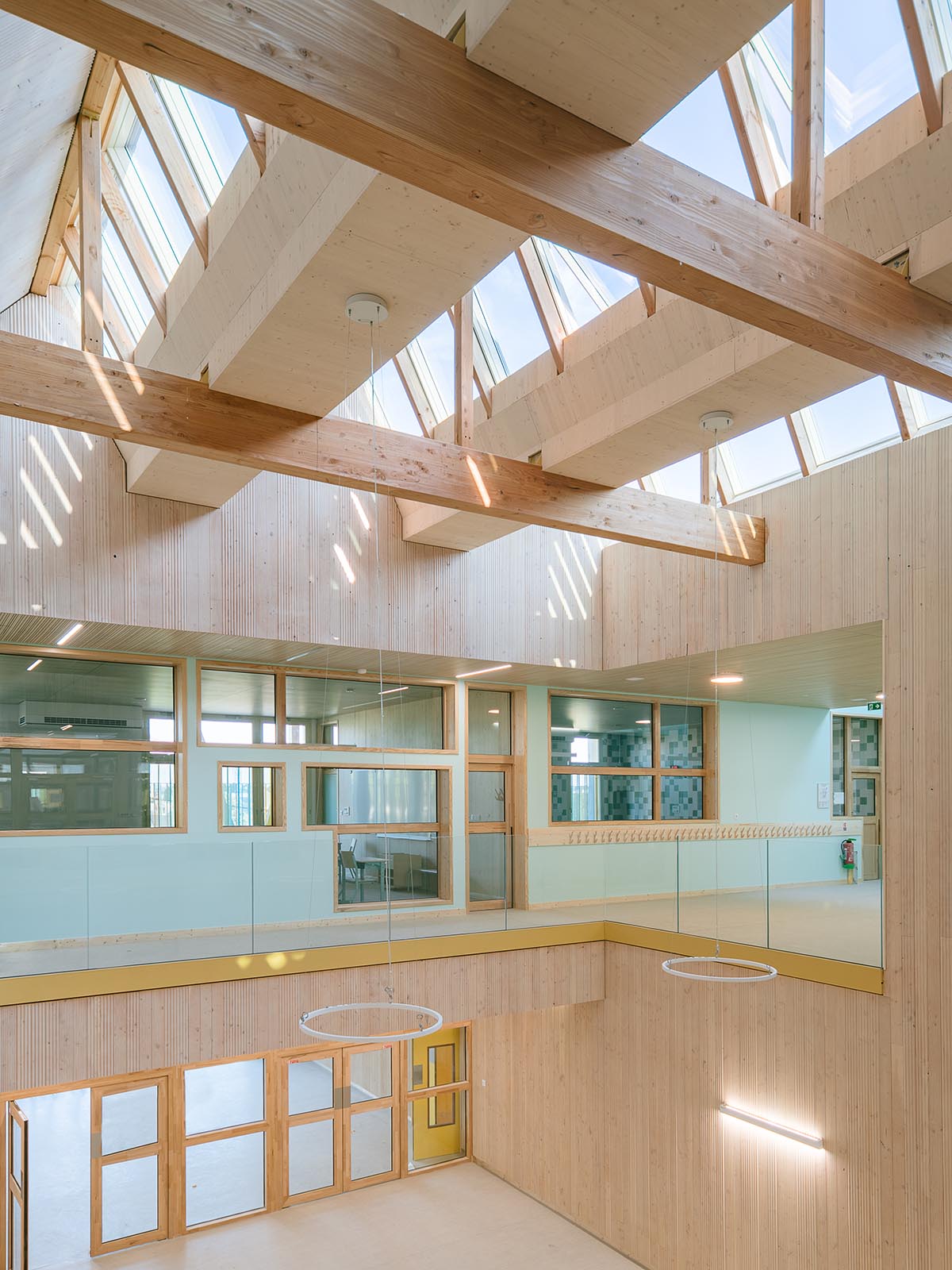 Wooden school by r2k architecte is inspired by Nordic architecture to be a positive energy building