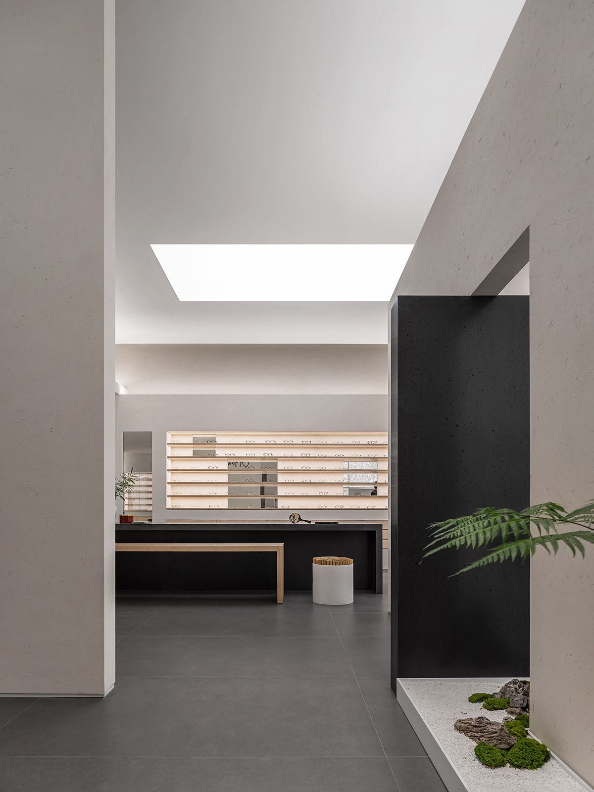 Luminous screen walls create fluid interiors for an optic store designed by Onexn Architects 