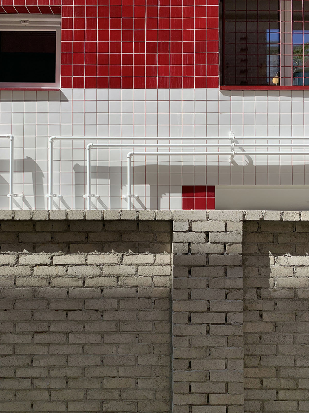 aoa architects uses red marble tiles to clad this apartment in South Korean neighborhood