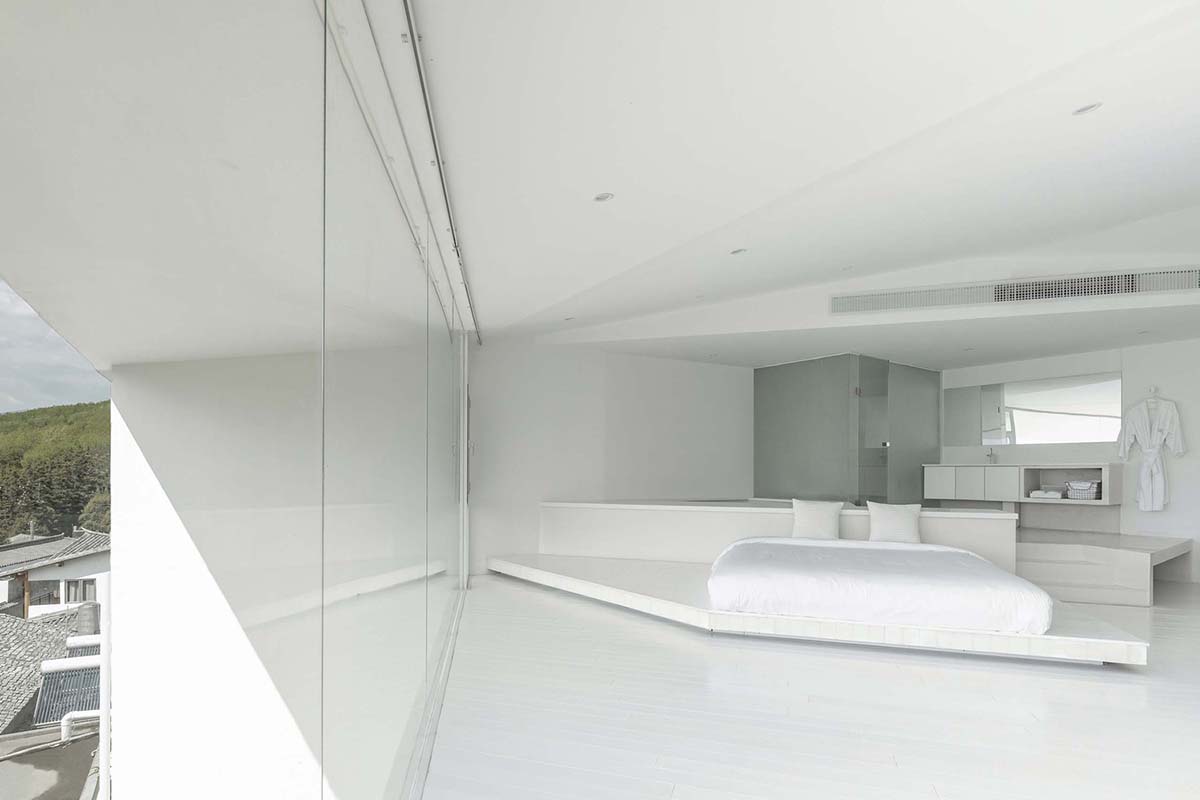 STUDIO QI reinterprets sequence of living conditions with tilted hotel on a hilly plot in China