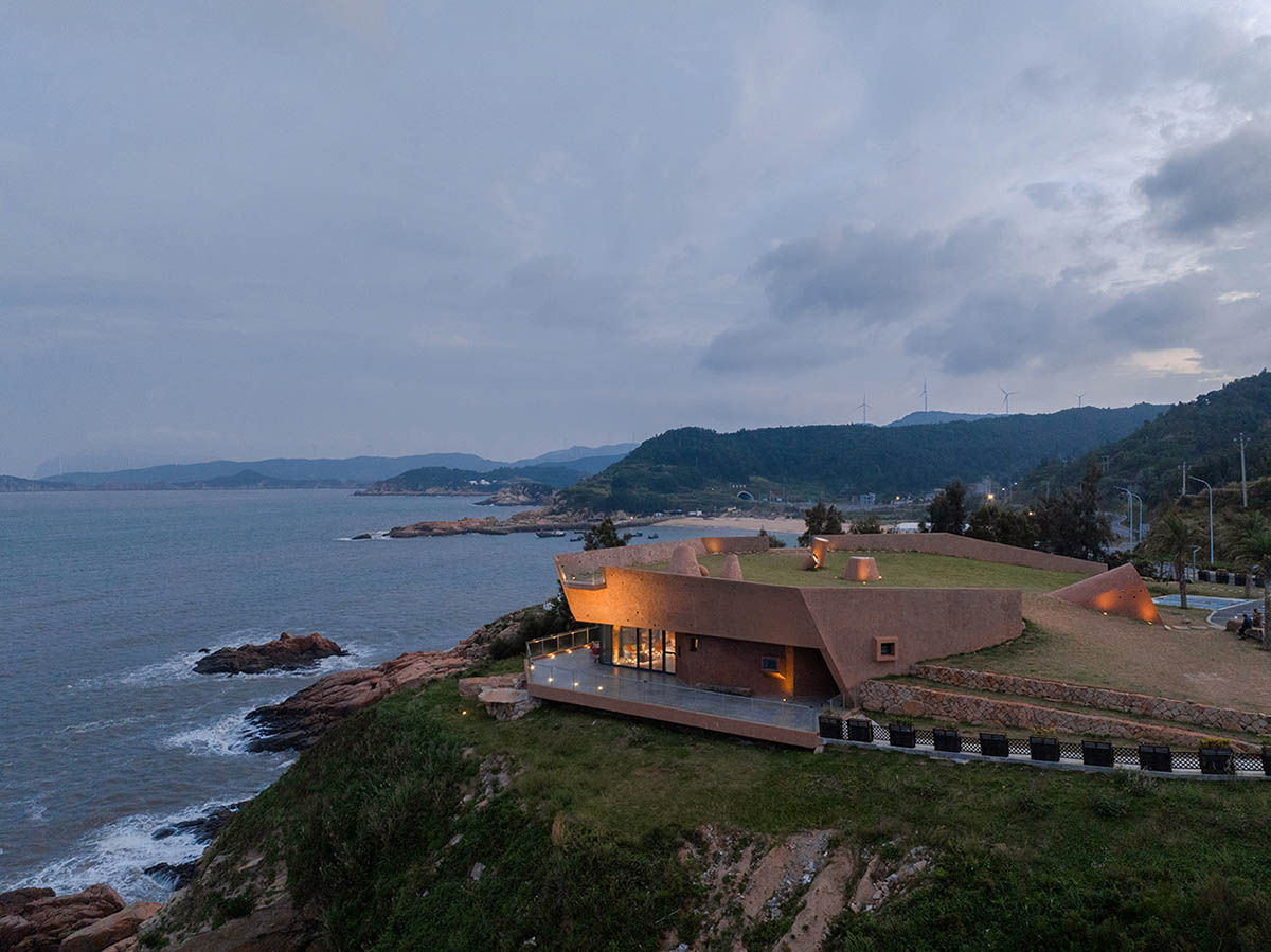 A gallery on a cliff features irregularly shaped lighting tubes that mimic marine creatures in China