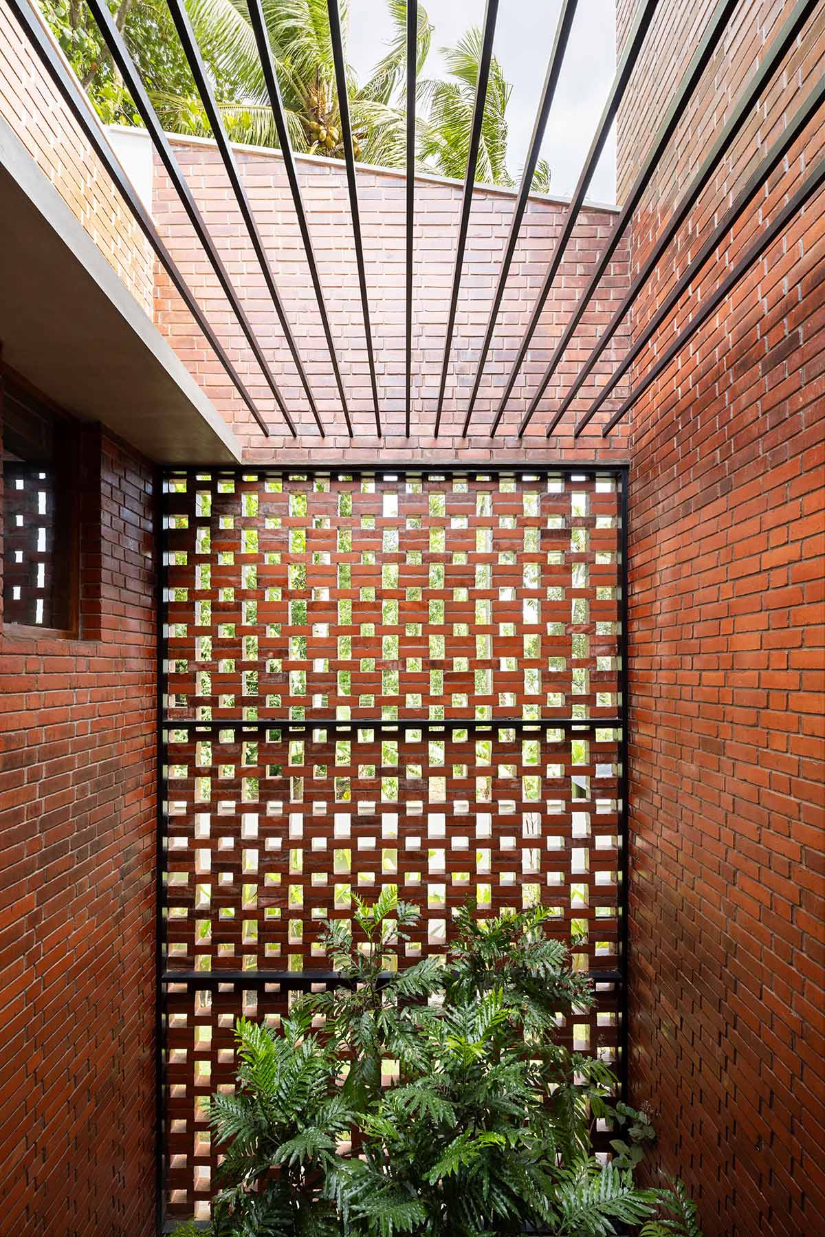 Srijit Srinivas - ARCHITECTS built brick family house with angled triangular façade in Kerala
