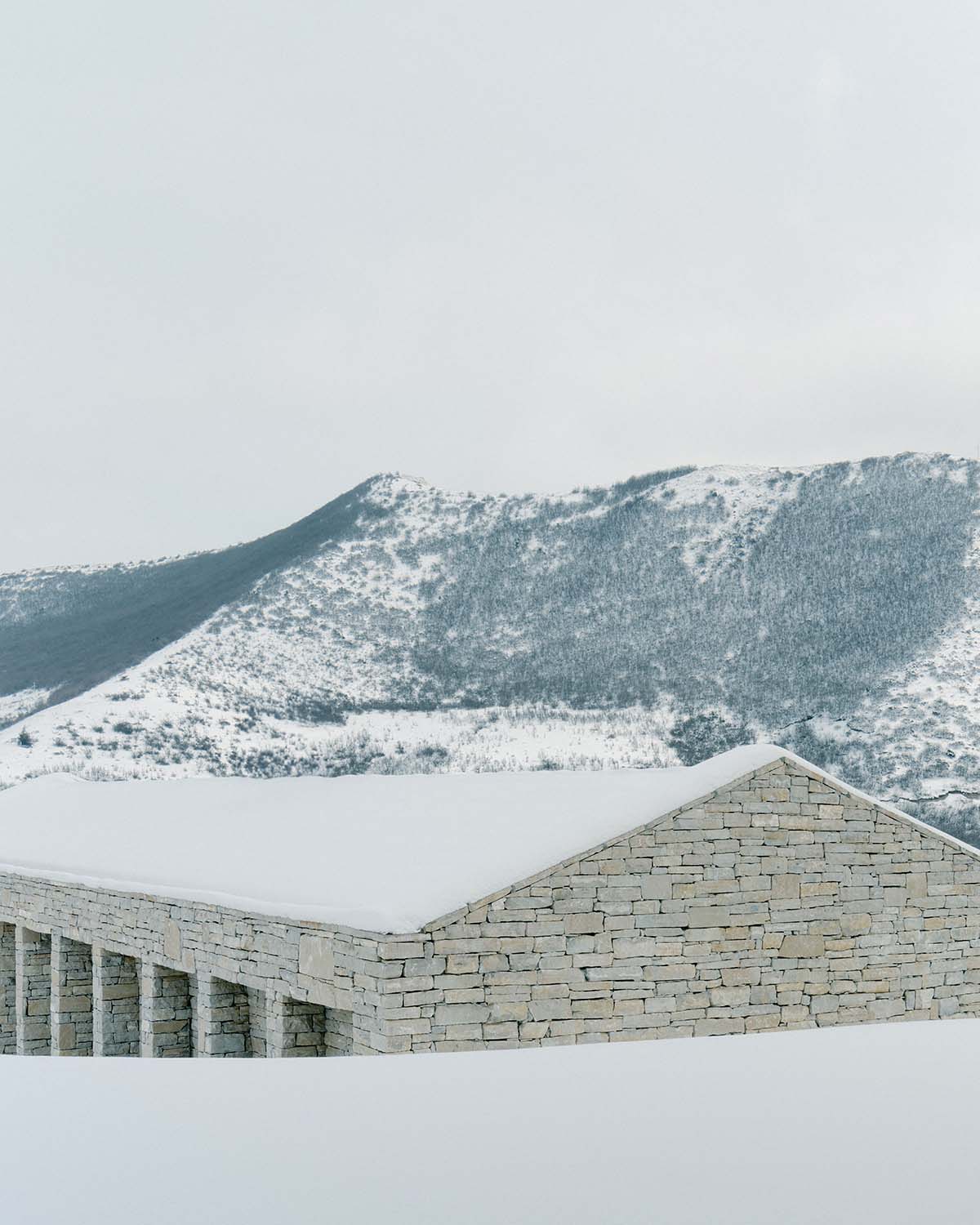 The stone and wood Tbilisi residence integrates architecture with the natural landscape