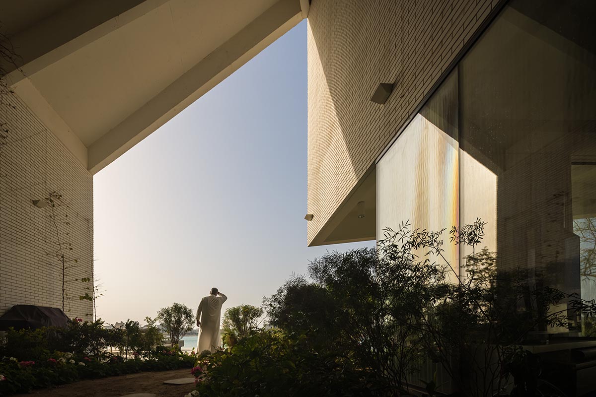 Family house is covered by folded roof to create a tent-like structure on Kuwait's seaside 