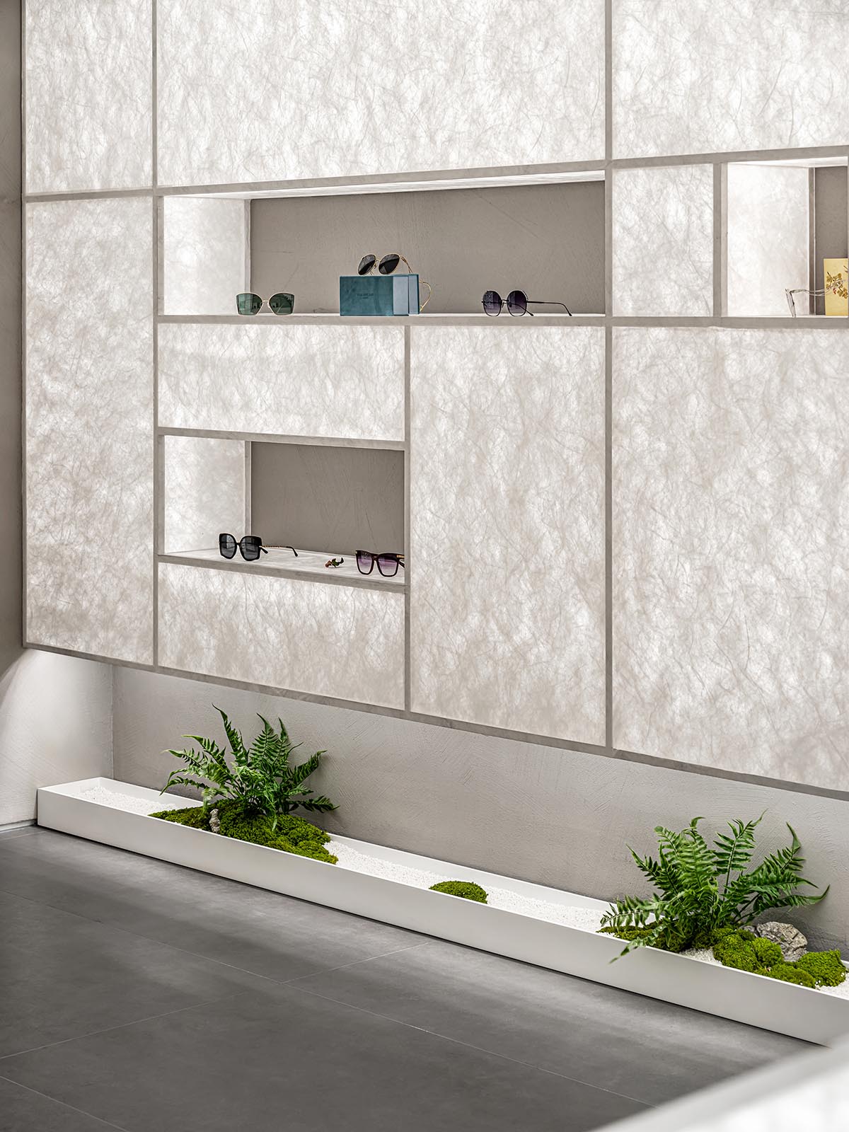 Luminous screen walls create fluid interiors for an optic store designed by Onexn Architects 